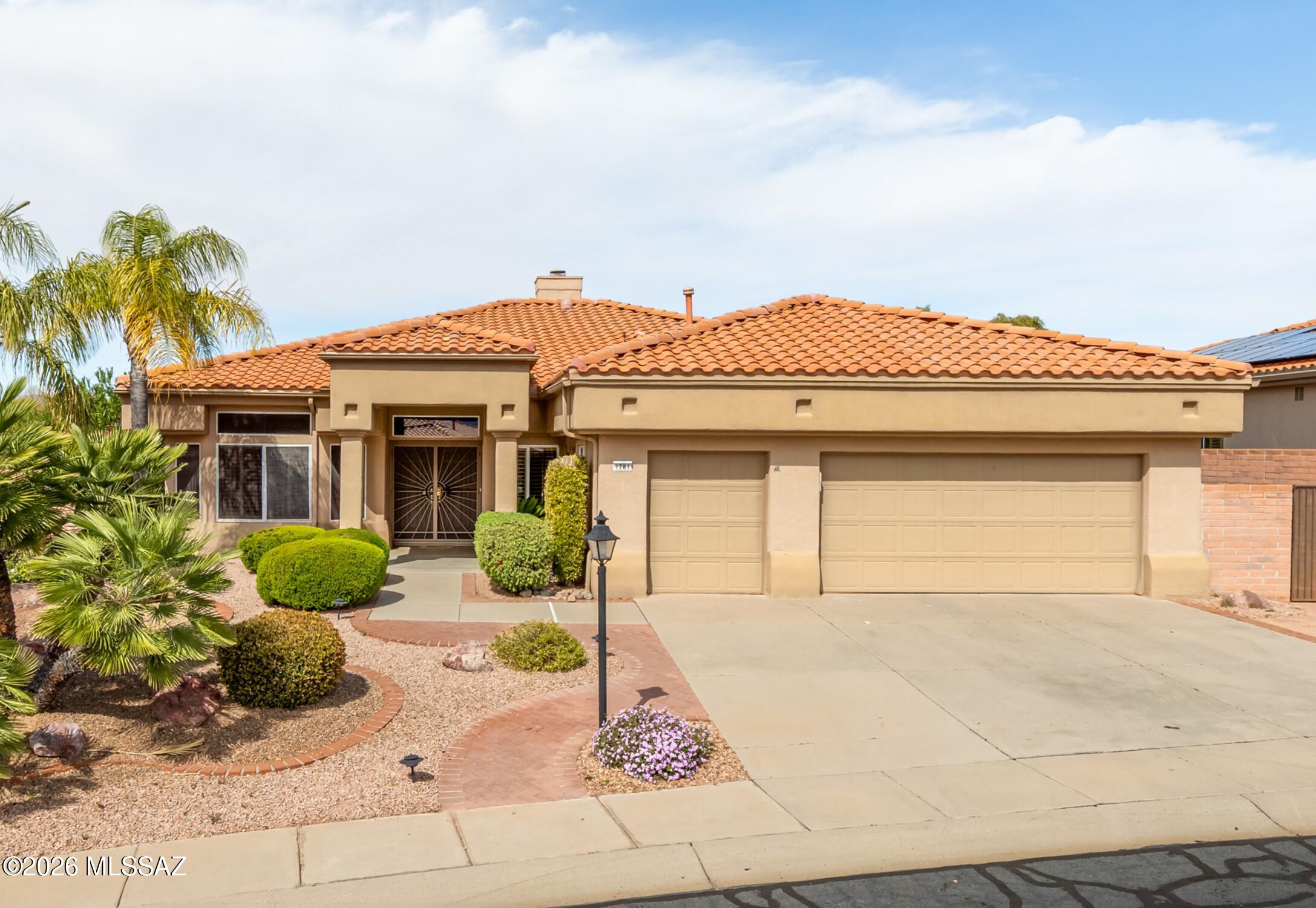 Perched on an elevated ridgetop lot in Sun City Oro Valley, this beautifully updated 2,251sf Ridgetop model showcases spectacular mountain, arroyo, & golf course views w/unforgettable Arizona sunsets as your daily backdrop. Designed to capture both natural light & sweeping vistas, the home offers an exceptional blend of elegance, comfort, & privacy. A grand double-door covered entry welcomes you into refined formal living/dining space accented by architectural columns, creating a warm & impressive first impression. Thoughtfully designed layout includes 2 BR/2 ½ BA, spacious den+bonus sitting area within the primary suite. The updated kitchen is both stylish & functional, featuring granite countertops, maple cabinetry, center island, pantry, built-in desk, breakfast area & newer sleek black appliances. Newer luxury plank flooring enhances the home's fresh contemporary feel, while plantation shutters, skylights, solar tubes, ceiling fans & custom Hunter Douglas sheer blinds provide soft natural light & privacy throughout. Family room centers around a cozy corner gas fireplace & flows seamlessly for everyday living & entertaining. Expansive primary suite offers tranquil views, patio access, custom walk-in closet & luxurious bath w/executive-height dual vanities, garden tub & separate walk-in shower. Comfortable guest bedroom w/nearby bath ensures privacy for visitors & convenient powder room adds additional functionality. The laundry room includes built-in cabinetry, countertop workspace & utility sink. Newer HVAC system adds peace of mind. Outdoor living is equally impressive w/covered brick patio, extended Alumawood Ramada, motorized sunshades, soothing water feature, flagstone walkways & cactus garden all perfectly positioned to enjoy panoramic golf course & mountain views. 2 ½ car garage allows for golf cart parking w/epoxy floors, workbench & abundant storage cabinetry. Residents enjoy access to championship golf, tennis and pickleball courts, swimming pools, a fitness center, recreation facilities, clubs, classes, concerts & countless social activities all set against the stunning Santa Catalina Mountains. With its elevated setting, thoughtful updates & vibrant community lifestyle, this home delivers the perfect balance of luxury, comfort & active desert living.