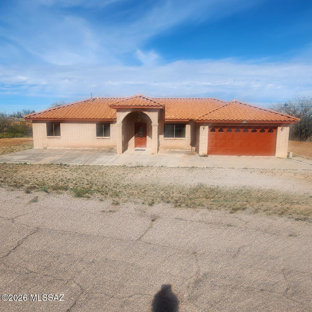 Masonary home in Rio Rico Estates 8 off West Ruby Road features a concrete tile roof built in 2006, a view .56 acre lot, 3 bedrooms, 2 full baths with new marble vanities, all electric except the water heater and the range and oven, ceramic tile flooring, grids in all windows and door for added protection, and a double garage. Primary bedroom features two walk-in closets.