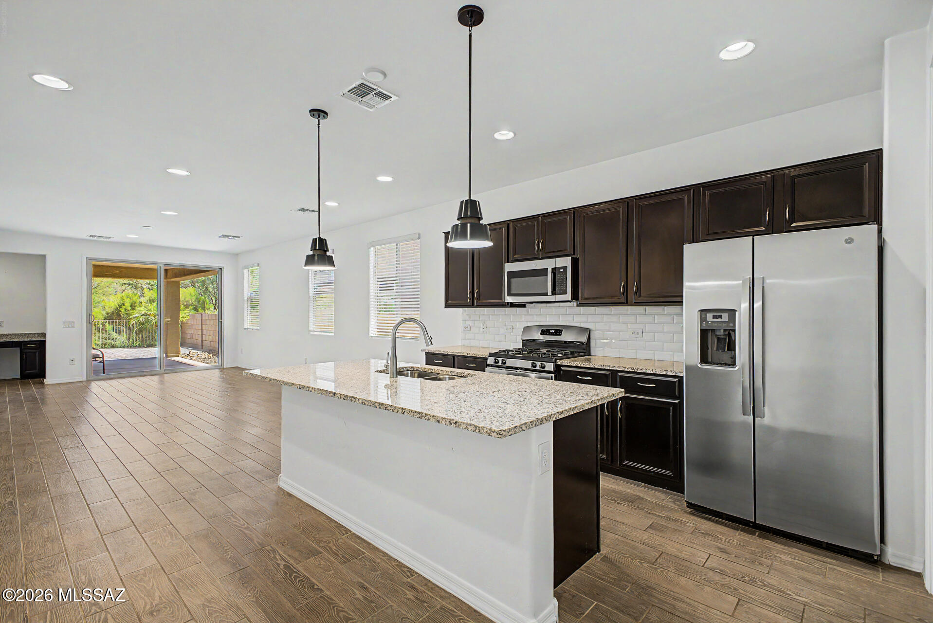 Breathtaking views in Rancho Vistoso. Beautifully maintained home in the heart of Oro Valley with a thoughtfully designed living space. Built in 2021, this home offers modern finishes, an open-concept layout, and stunning views of Pusch Ridge. A spacious kitchen with quartz countertops, a large island and a walk-in pantry offer perfect space for gathering. A built-in office nook provides the perfect space for working from home, homework, or additional organization. Step outside to a beautifully landscaped backyard with no rear neighbors where you can relax and enjoy Arizona sunsets and mountain views. Located in the desirable Rancho Vistoso community with nearby parks, trails, shopping, dining, and top-rated Oro Valley amenities, this home is ideal as a family home close to schools and Naranja Park  or a winter retreat with nearby golf and country club options.