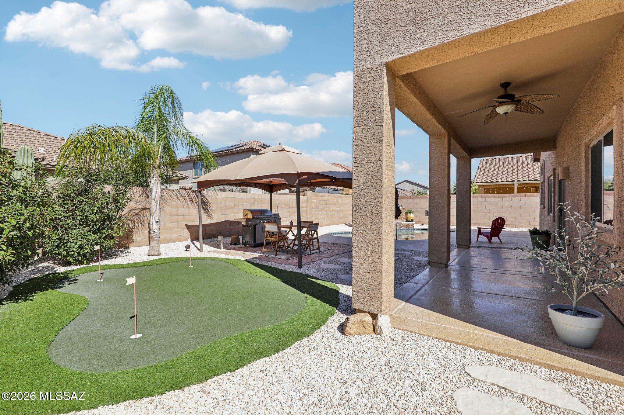 IDEAL LOCATION!! Tucked away in one of Marana's most sought-after neighborhoods, this stunning 3,185 sq. ft. home delivers the perfect blend of comfort, with the effortless indoor/outdoor lifestyle you've been dreaming of! Seller will consider offers between $474,900-$494,900. Let's begin with a resort-style pool, and ascading waterfall that invites you to cool off during those warm desert evenings, while raised privacy walls create a secluded oasis that feels entirely your own. Sharpen your short game on the private putting green, then relax under the expansive covered patio surrounded by low-maintenance turf and elegant pavers. Whether you're hosting friends or enjoying a quiet evening under the stars, this backyard delivers it all. This home is completely ''Move-in-ready'' with all new interior paint, carpet and beautifully updated bathrooms that bring a modern touch to every corner of the home. Beyond the front door, Marana's lifestyle is second to none. Nestled in the foothills of the Tortolita Mountains, you're surrounded by panoramic Sonoran Desert views, 29 miles of scenic hiking and biking trails, and easy access to the Forbes Five-Star Ritz-Carlton at Dove Mountain, one of Arizona's premier resort destinations. World-class golf, fine dining, shopping at Tucson Premium Outlets, and the best of Tucson are all just minutes away, Top-rated Marana Unified School District schools, vibrant community parks, and a welcoming small-town feel round out a lifestyle that checks every box. Homes like this, that are move-in ready with a backyard this extraordinary, don't last long so put the family in the car and some see this gem for yourself.