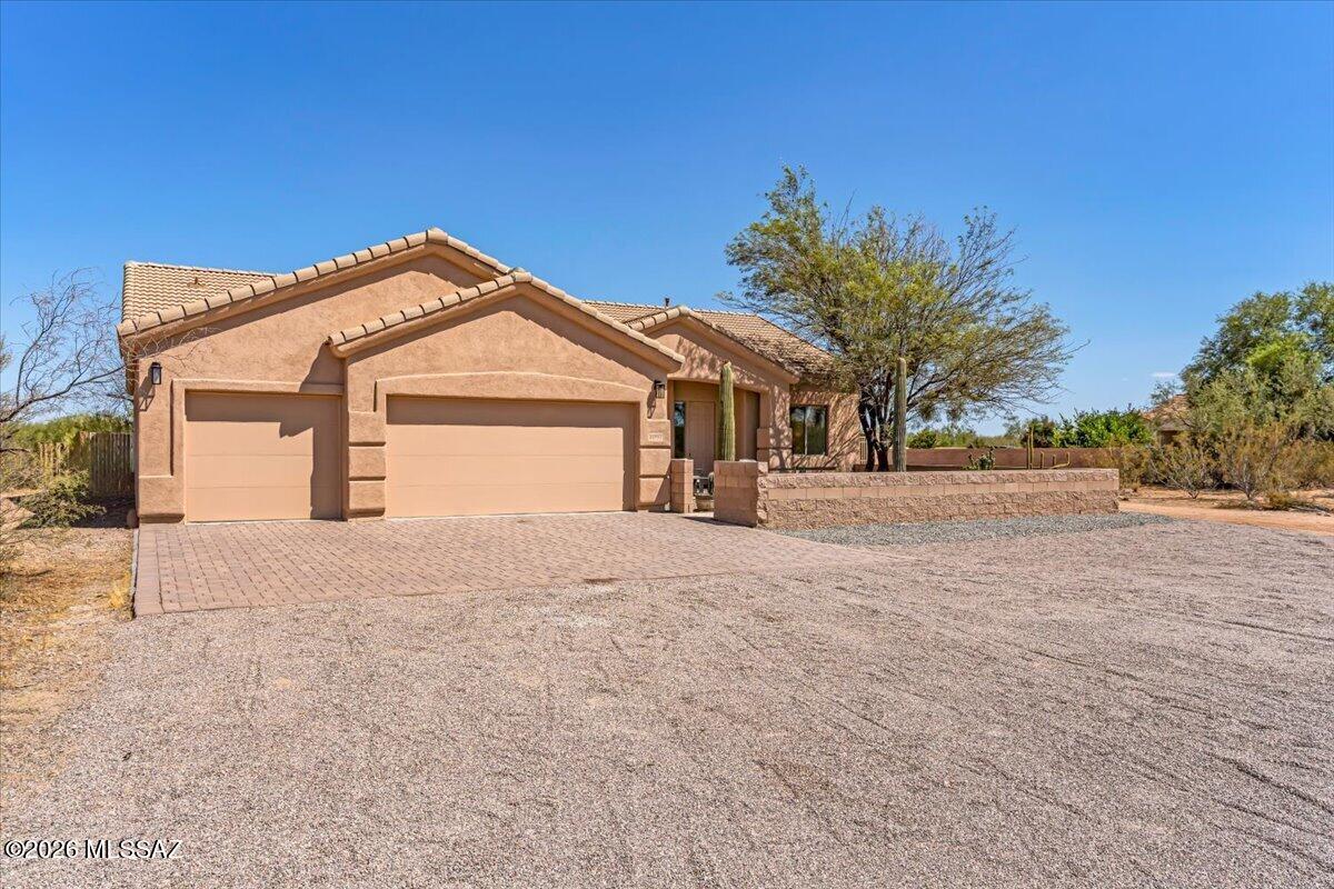 Experience refined rural living in this beautifully updated, contemporary-style home in Avra Valley. Spanning 2,574sqft of open concept, split-floor plan living, this 3bed, 2bath retreat was perfectly designed for everyday lifestyle and entertaining. Featuring a NEW tile roof, exterior paint, gravel driveway, window shades, and primary closet system, this property is truly turn-key and ready for its next chapter. Combining luxury with utility, this property also features a three-car garage and a detached metal storage facility. Outside, find the custom paver patio within the oversized courtyard, lined with mature trees and a cactus garden, perfect for morning coffee or sunset gatherings. A rare opportunity to find convenient modern updates and timeless finishes in a rural desert setting.