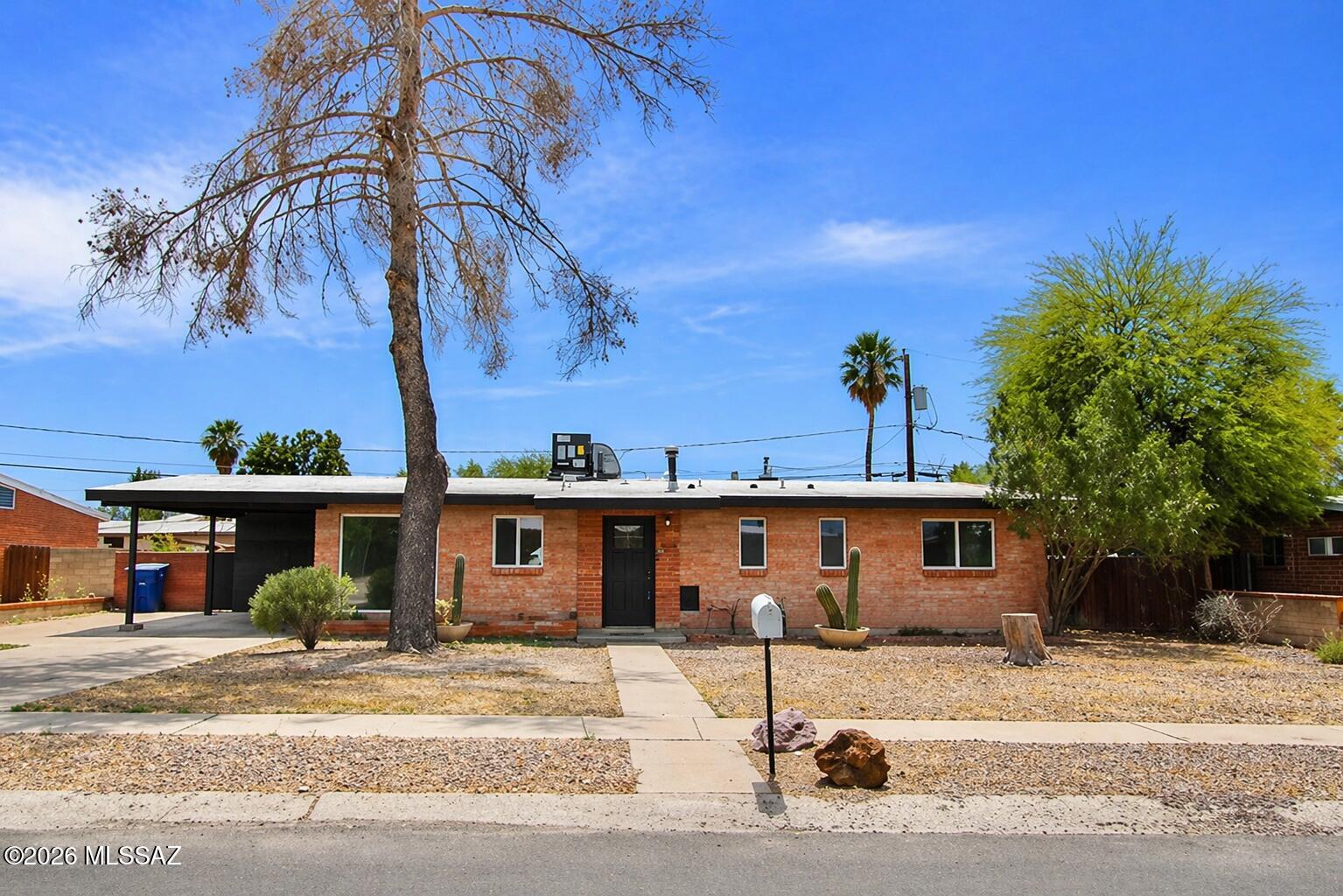 Renovated brick home featuring 3 bedrooms and 2 bathrooms, move-in ready with NO HOA! This property offers carport parking and a bright, modern interior. Enjoy vaulted ceilings, abundant natural light and new wood-look flooring throughout. The updated kitchen boasts stainless steel appliances, granite countertops, subway tile backsplash, white shaker cabinets, and a center island with breakfast bar. Spacious bedrooms and beautifully updated bathrooms add to the appeal. Step outside to a large backyard with a covered patio, providing the perfect canvas to create a complete outdoor oasis. Prime location near Park Place Mall, hospitals, dining, and more!