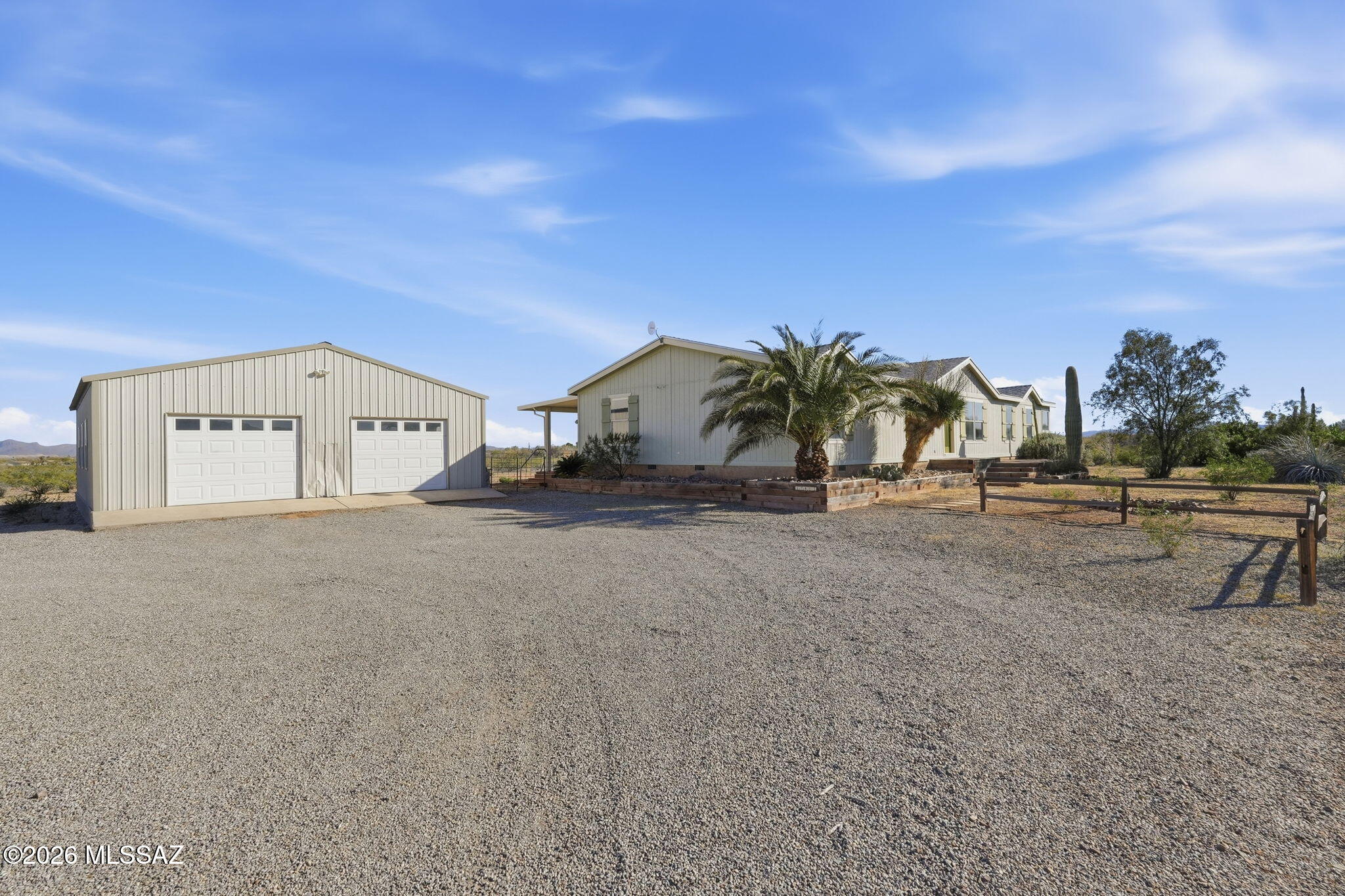 Set on 8.2 acres across two parcels and zoned for horses, this private desert retreat is defined by its expansive outdoor living and sweeping 360-degree mountain views. There is ample space for riding, animals, gardening, or simply enjoying the quiet of the open desert. Inside, the 4-bedroom, 2-bath home showcases custom woodworking, a statement fireplace, and a welcoming sunken family room. The open kitchen features a large multi-level island, walk-in pantry, and abundant storage. The primary suite offers dual sinks, a soaking tub, and separate shower. A detached four-car garage/workshop complete this rare blend of craftsmanship, privacy, and land.  This is one not to be missed. Roof replaced in 2022! HVAC was replaced in 2019! 120/220 electrical in Garage for all your tools or for an RV.