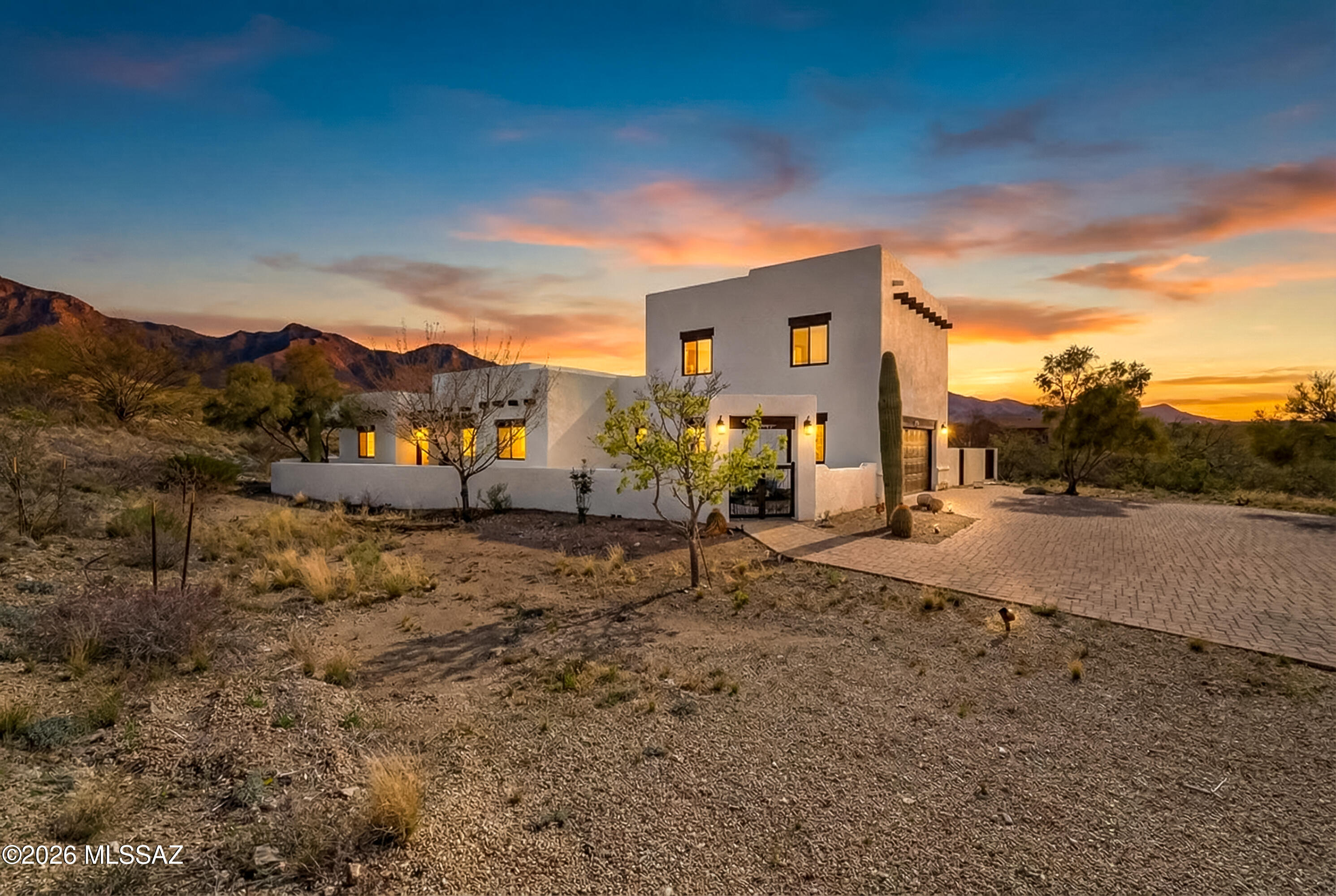 Range pricing of $775,000-$800,000. Experience breathtaking sunsets and panoramic mountain views from this stunning Pueblo-style desert oasis nestled on over an acre! Located in the acclaimed Vail School District with NO HOA, this 5BD/3.5BA home beautifully blends authentic Southwestern charm with fully integrated smart-home technology. The striking exterior features crisp white stucco, exposed vigas, a sweeping paver driveway, and a walled courtyard with mature saguaros. Inside, the bright, open-concept living space boasts wood-look flooring, elegant archways, and a cozy dark fireplace. The split floor plan offers three main-level bedrooms, making it an excellent option for multi-generational living. Entertain effortlessly as large sliding doors provide a seamless flow to the resort-style backyard, complete with a pebble tec pool, spa, outdoor kitchen, generous ramada, and an outdoor fireplace.

Control it all from your phone with Alexa voice commands for indoor/outdoor lighting, climate, pool/spa heating, and security cameras. Enjoy easy access to Raytheon, DMAFB, Tech Park, the AZ Trail, and local vineyards, plus plenty of room to park your toys. Welcome home!
