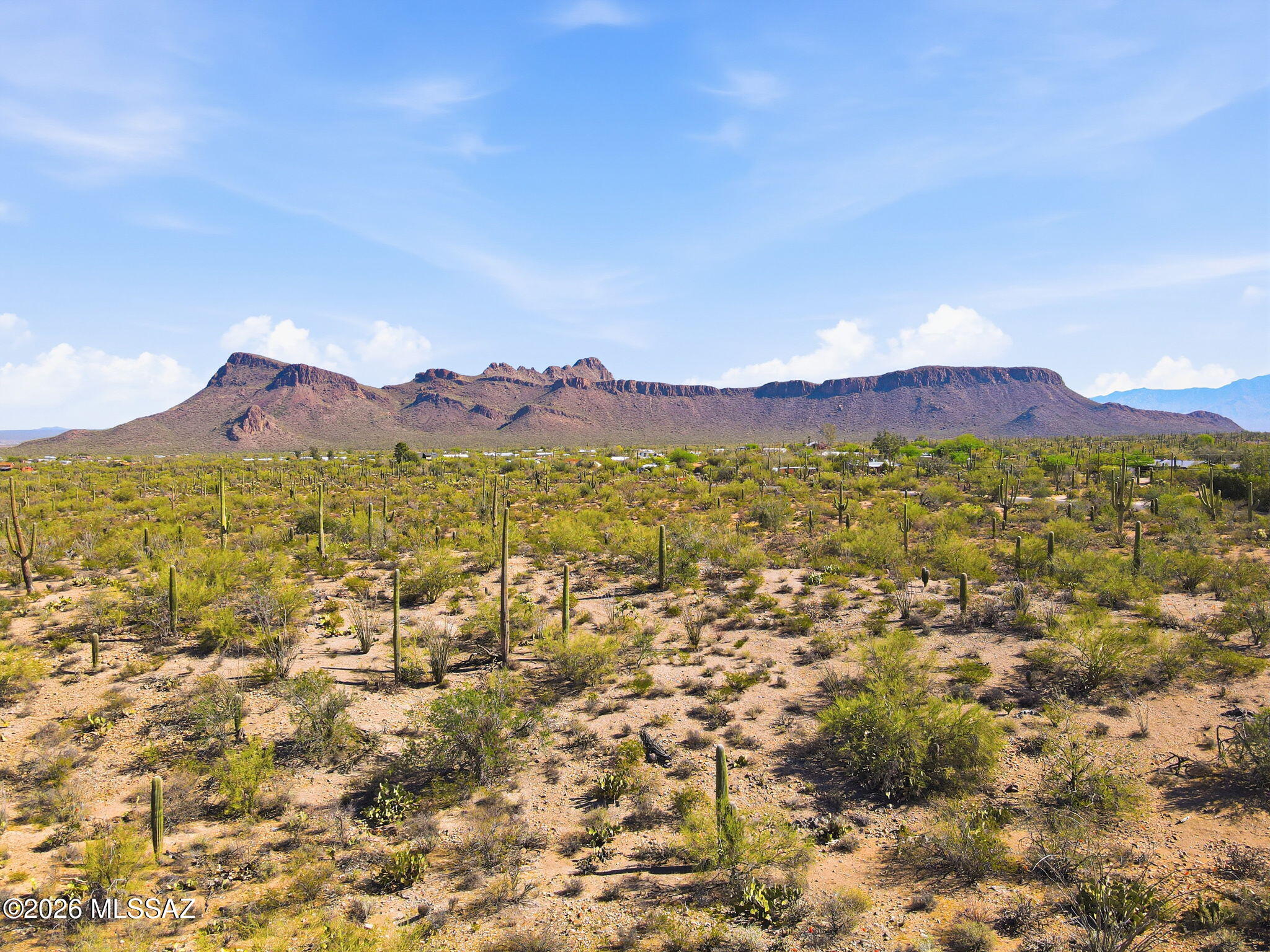 NEW CUSTOM LOT SUBDIVISION of 1+ acre lots: all with PANORAMIC mountain views. LUSH vegetation dotted with SAGUAROS and LEVEL or GENTLY SLOPED building areas. Choose RIDGETOP sites with views across Avra Valley, and the peaks of NEARBY Saguaro National Park or nestle in flat, well vegetated sites for PRIVACY.  Only 11, Phase 1 parcels available, priced from $152,000 to $164,000. Sites serviced by water, electric, phone and cable with HOA fees of only $125 per year. Single level homes required with a minimum 1800 sq. ft. and 20'  height restriction.   Choose your builder or ask about the available Dell Mar Homes models. Approx. 13 minutes west of the Ina/I-10 intersection for convenient Downtown, U of A and Airport access. Shown by appointment only during construction. CALL TODAY.