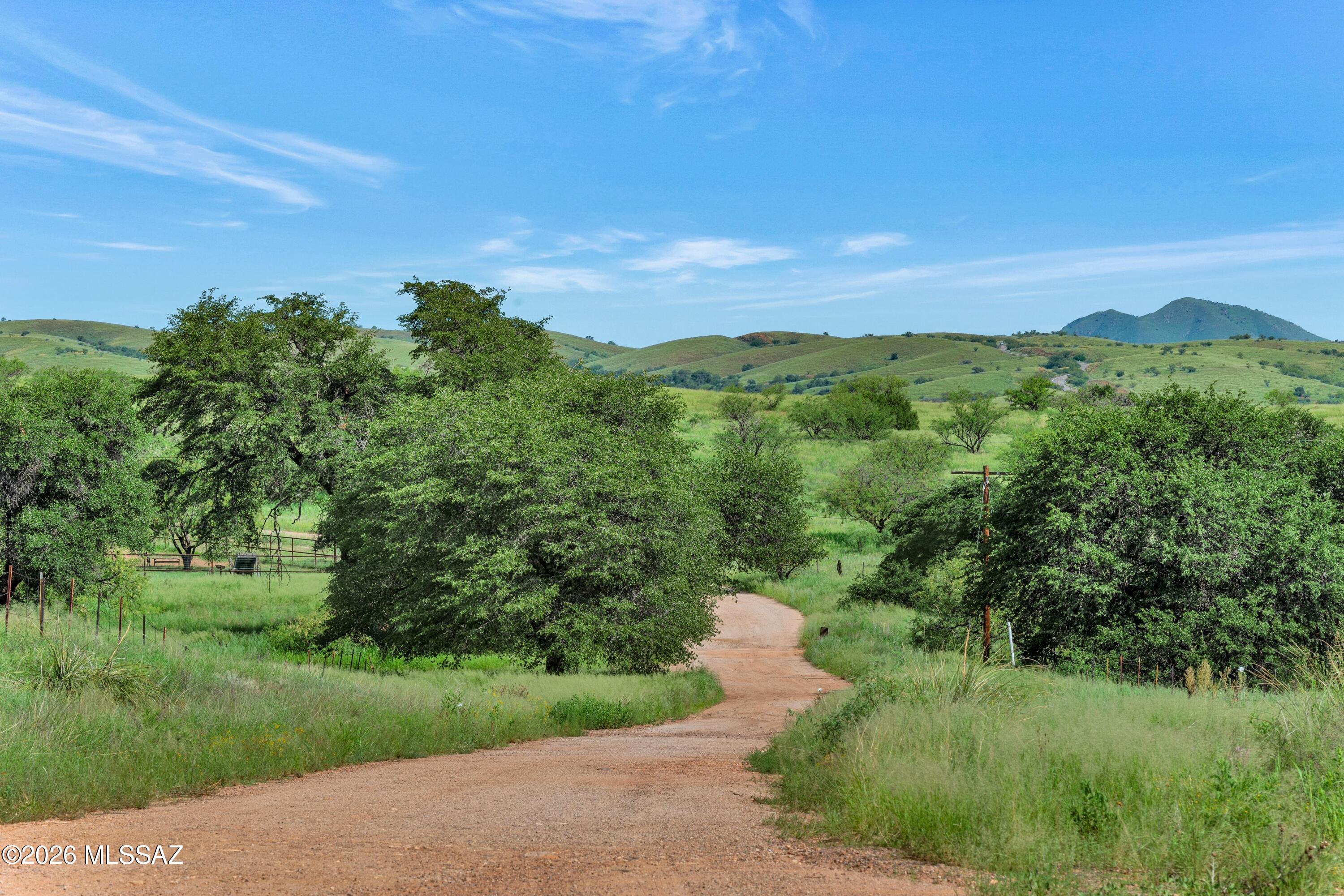 36+ acres in the gated Hidden Hills community. Rolling hills, mature trees, and expansive native grasslands create an exceptional setting for your dream ranch or private oasis. A recently added well producing 35+ GPM provides an outstanding water resource for the property. Enjoy breathtaking mountain views, approximately 4,800 feet in elevation, and abundant open space with the ability to ride directly through the Forest Service gate to the west and access BLM lands to the east. The thoughtfully designed HOA helps preserve privacy and reduce the impact between neighboring residences, allowing you to enjoy the peace and quiet of this large-lot development. Located approximately 40 minutes from Tucson International Airport, with the Sonoita wine country nearby, this property offers a combination of rural seclusion, recreational access, and convenient proximity to Tucson amenities. An adjacent 18+ acre parcel is also available, offering the opportunity for approximately 54 acres of contiguous private land. Bring your vision and create the Arizona retreat you've been waiting for.