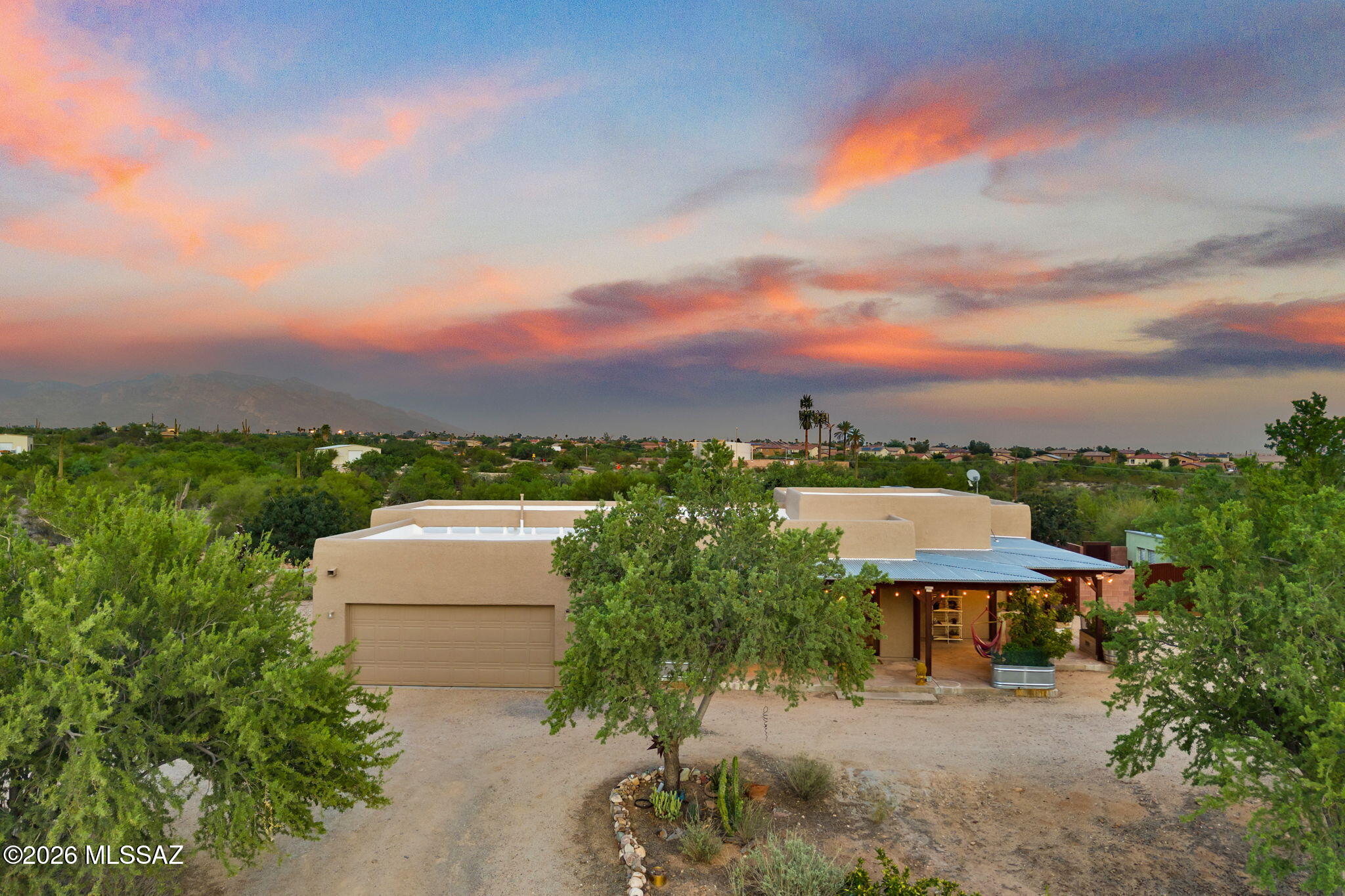Rare opportunity to own a truly special Tucson property, lovingly designed and built by its original owner. Set on over 4 acres, this 5-bedroom, 3-bath home offers space, privacy, and a lifestyle that is increasingly hard to find. Thoughtfully constructed with Structural Insulated Panels, the home offers a unique combination of energy efficiency, strength, and quality construction. Step outside and discover your own private oasis, complete with a saltwater pool, water feature, and slide--perfect for relaxing, entertaining, and making lasting memories. The grounds are filled with mature fruit trees supported by irrigation, creating a beautiful and productive landscape with plenty of room to enjoy the outdoors. Covered front and rear porches provide the perfect places to start your mornings with peaceful sunrises and wind down your evenings while taking in spectacular Arizona sunsets. With over 4 acres, there is plenty of room for outdoor living, gardening, hobbies, animals, or simply enjoying the privacy and open space surrounding you. This is more than a home--it is a property with character, history, thoughtful construction, and room to live life on your terms. Opportunities like this, with acreage, a private well, mature landscaping, and a resort-style pool, are truly special.