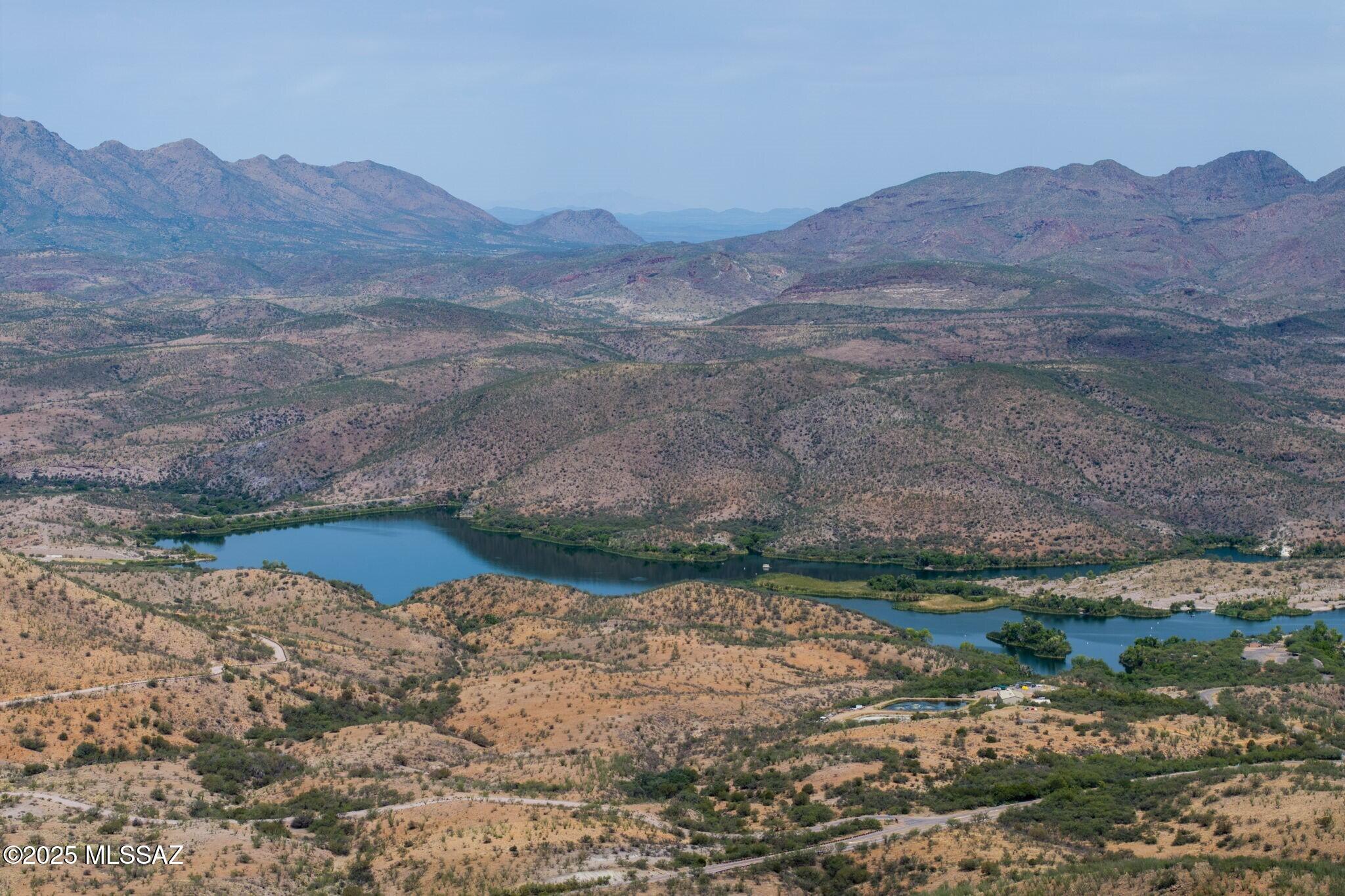 Plan your escape with this spectacular 36.56-acre lot of wide-open Arizona landscape where privacy meets unlimited potential. Along its north boundary, the property borders 2,658 acres of protected natural terrain encompassing Arizona state land and Lake Patagonia State Park. You'll enjoy sweeping panoramic views which include Patagonia Lake, a local favorite for kayaking, fishing, boating and camping enthusiasts. Gated entrances and a 1.5 acre seasonal pond offers potential for a livestock or equestrian property. The versatile and expansive lot offers space for a single spectacular ranch retreat or for multiple prime homesites when you're ready to develop. Experience the space, scenery and freedom of this unspoiled landscape and bring your vision to life.
