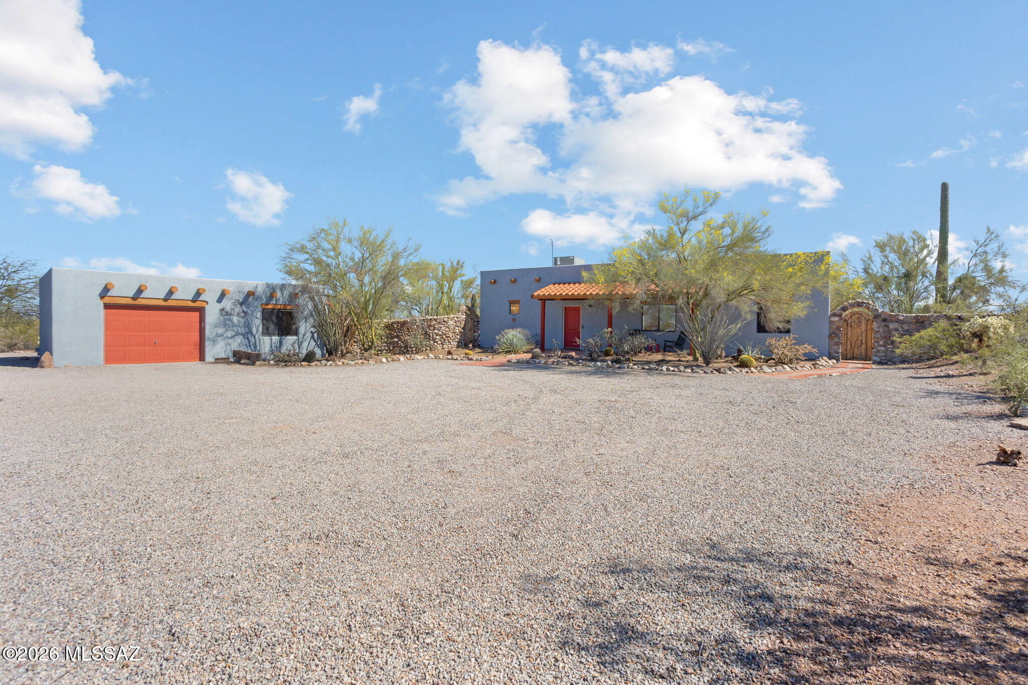This beautifully maintained and truly unique property sits on 4.62 acres within the stunning Ironwood Forest National Monument. Featuring 2 bedrooms, 2 bathrooms, and a versatile office/den, this home offers privacy, open space, breathtaking views, and endless possibilities--all with no HOA.

The home includes all kitchen appliances, as well as a washer, dryer, and water softener. The primary suite features direct outdoor access, a walk-in closet, and a spacious walk-in shower.

A detached guest room/studio includes a sink, mini fridge, and full bathroom--perfect for visitors or flexible use. The property also offers a two-car garage, plus an additional detached garage/workshop. There is a hot tub pad with water and power hookups, as well as an RV hookup next to the garage. The true highlight of this property is the spectacular outdoor setting, with many saguaro cacti, incredible star-filled nights, and sweeping views, including the iconic Ragged Top mountain peak.

Ironwood Forest National Monument protects 129,000 acres of pristine Sonoran Desert landscape. Named for its dense ironwood tree populations and managed by the Bureau of Land Management, the monument features rugged mountains, diverse wildlife such as bighorn sheep, and significant archaeological sites from the Hohokam period. Outdoor activities include hiking, biking, birdwatching, sightseeing, and off-roading.

Furniture, tools, and décor are available under a separate bill of sale.