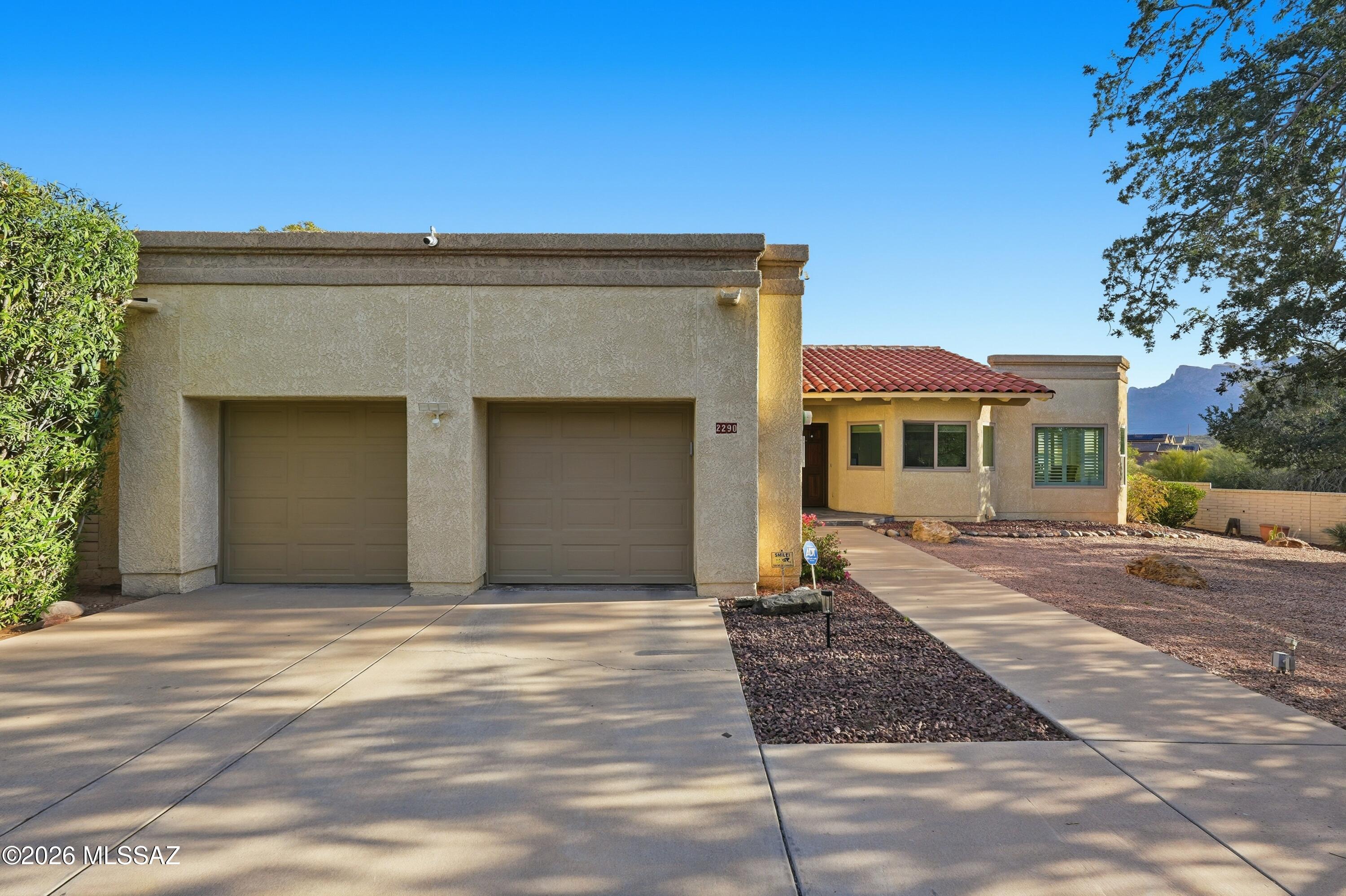 This home qualifies for forgivable down payment assistance of up to 4%. See the attached flyer in the documents tab; specific terms apply.

Privately situated at the end of a cul-de-sac in the hillside gated community of Alta Mira, offers a 1,947 square foot desirable northwest retreat with rare seclusion, with only one neighbor on a 0.32-acre lot. The two split-bedroom plan, two-bath home features large walk-in closets, tasteful window treatments, ceramic tile floors, and newer high-end neutral carpet in the living room and bedrooms. Enjoy updated baths with quartz countertops and updated showers. The kitchen includes stainless steel appliances, double ovens, a smooth electric cooktop, and plantation shutters, which are great for light control. With an additional flex space that easily fits its current use of an eight-seater dining table for entertaining, enjoy the tasteful built-in dry beverage bar with dual-zoned beverage fridge. The attractive new lifetime-warrantied Milgard four new easy-open sliders and windows throughout eliminate potential traffic noise and offer excellent energy efficiency, complemented with Solar power. Full of natural light with oversized skylights throughout that offer a bright, airy feel as well. Panoramic mountain views and entertainer-friendly patios bring the Catalinas to center stage. The wrap-around pavered patio will easily accommodate a spa or outdoor kitchen; the sky's the limit to outdoor living to add to this very unique, special property. Not to mention the terraced yard includes a greenhouse on a concrete slab, great for gardeners or extra storage. The two-and-one-half-car garage features a utility sink, central vacuum, new water softener, extra storage, an installed mini split for a potential A/C'd workshop space, and a beverage center that may keep the hobbyist busy year-round for many hours to enjoy all this home has to offer. Come check it out, it's priced to sell, updated homes in this community don't come around often. Check out the "Upgrades document" highlighting over $50k in upgrades done to this home. Newly coated roof and newer HW tank, 1-year-old HVAC, and so much more!