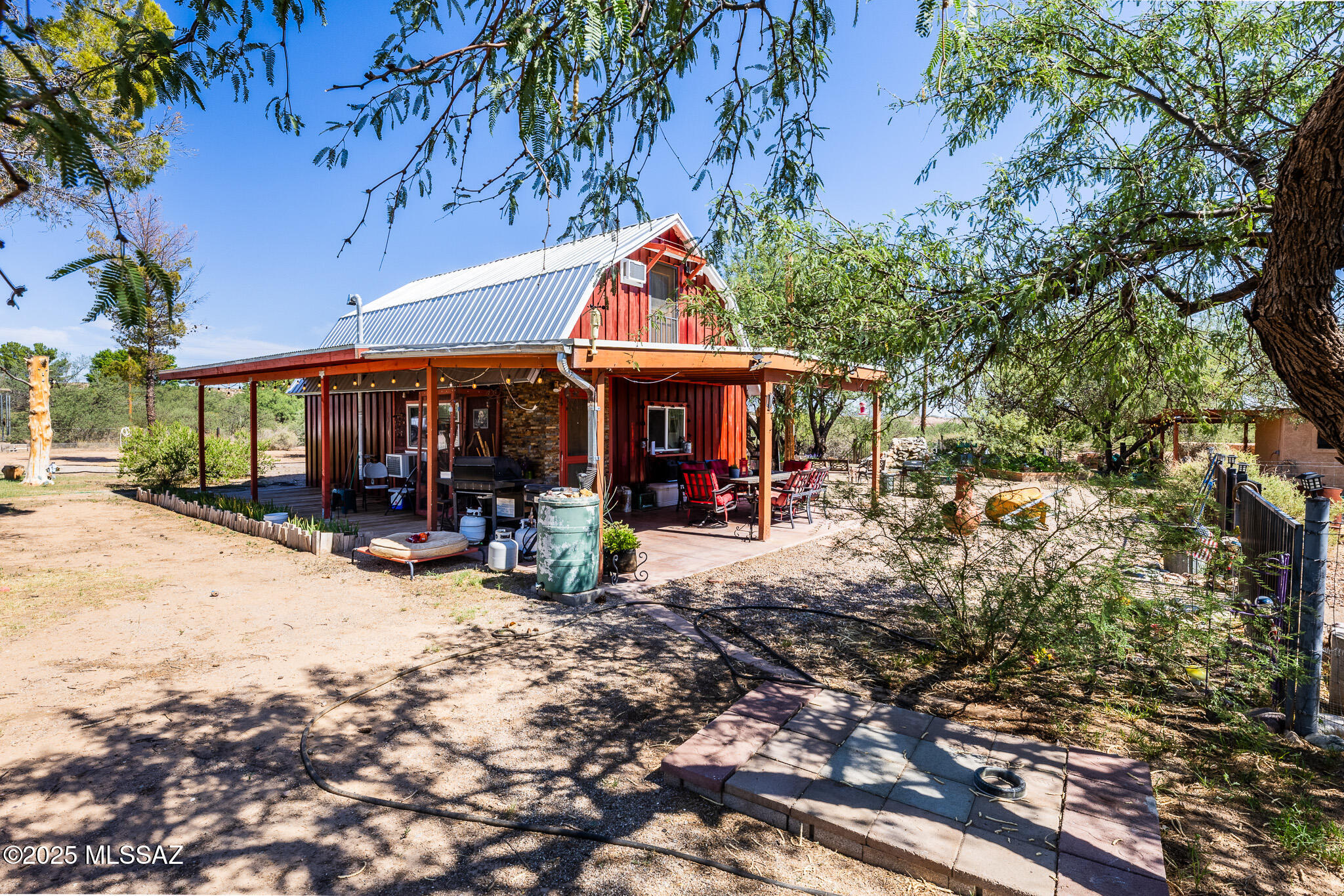 Experience country living with this inviting 2 bedroom 1 bathroom barndominium set on 19 acres. Warm and welcoming, this home features a cozy, pellet burning fireplace and great views of the surrounding landscape. Great for a versatile lifestyle, this property offers horse facilities, a spacious workshop, a charming garden casita, an aviary, a greenhouse and a water fountain. This property provides open space, privacy and blends comfort and beautiful scenery in one great place complete with private well, a new septic installed in 2025. Property is sold ''AS-IS''