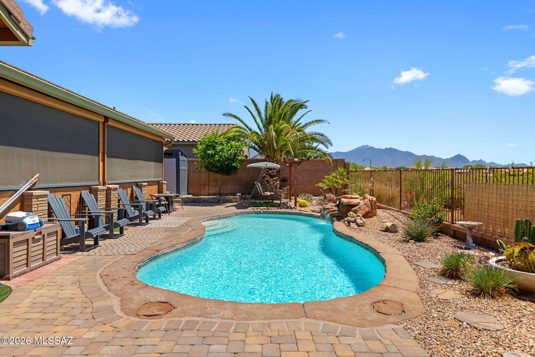 Amazing opportunity for updated 2,987 SqFt 3 bed/2.5 bath split floor plan with den and flex room, single story w/no stairs/no steps, 2009 built modern contemporary home on premium .22 acre elevated view lot featuring unobstructed panoramic Sonoran desert and Santa Rita mountain views, seller owned solar photovoltaic panels, heated pool, 633 SqFt attached 3 car finished garages located in the desirable gated community of Madera Highlands Encore. Featuring NE/SE orientation, mountain views, no neighbors in front or behind, modern flat concrete tile roof, concrete driveway, concrete sidewalks, freshly painted outside ($6500), on and off-street parking, landscaped manicured front yard w/crushed rock, Saguaro cactus, fruitless olive and palm trees, custom rustic garage doors, metal gutters, concrete walking path to secure gated enclosed front patio. Inside enjoy tall textured ceilings (no popcorn), energy efficient double pane windows, new custom matching blinds, solar window screens, luxury plank and tile flooring throughout (no carpet), built-in ceiling fire sprinkler suppression system, crisp white 8' internal doors, ADT alarm installed, zoned gas Trane HVAC system (new 2023 $27K),  dual digital Smart thermostats, Pex plumbing (no polybutene), plumbed whole home water filtration Green water softener & carbon filter system (new 2024 $3200), recessed lighting, luminated ceiling fans and formal dining area. Entertainer's dream open concept kitchen featuring full slab granite counter tops, matching massive full slab granite island with bar seating, self-closing designer staggered modern kitchen cabinets with lower cabinet pull-out shelves, stainless steel appliance package, convection oven, brick backsplash, butlers pantry with walk-in closet, laundry room with exhaust fan, washer and dryer included, adjacent to spacious great room with fantastic natural light, built-in 4 speaker surround sound and gas fireplace. Endless possibilities for the attached enclosed West facing tiled flex room, currently used as a home gym, with remote control outside electric powered shades. Large primary suite with full ensuite bathroom featuring dual walk-in closets, separate soaking tub, walk-in shower and matching dual executive height cultured marble modern vanities.
Attached 633 SqFt finished 3 car garage with remote controlled garage doors, concrete floors, provide ample room for workshop, toys, golf carts or convert a stall to home gym.
Epic Tucson sunsets await from your private backyard retreat with open wash and no neighbors behind, providing 180° unobstructed Santa Rita mountain views! Relax in your sparkling heated pool year-round, soothing waterfall, new electric pool heater ($3824 in 2023), cartridge pool filter, variable speed pool pump, raised flower beds, orange and lime trees, Tuff shed storage, Belgard brick pavers, plumbed for gas grills, ramada, side gates, view fencing surrounded by HOA approved raised privacy block walls. 
Affordable $117 monthly HOA includes secure gated entrance, community pool, basketball courts, tennis courts, grassy park, extensive paved walking paths, street and common area maintenance. Call to make your appointment to view this gorgeous move in ready home today!