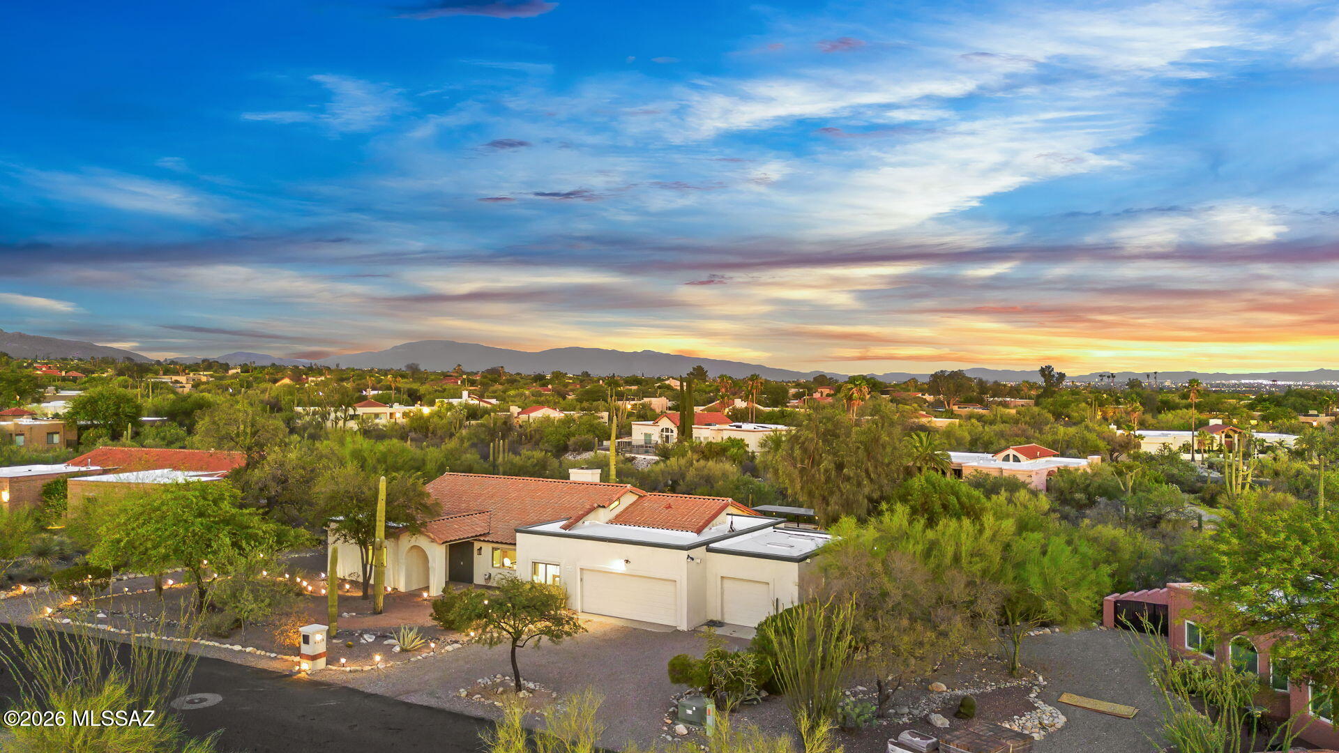 Open, elevated, and extensively renovated in Shadow Hills, this exceptional 3,048-square-foot residence offers the rare combination of panoramic views, a highly functional single-level floor plan, and nearly every major upgrade today's buyers are seeking. Set on a premium Catalina Foothills lot backing to a natural wash, the home enjoys remarkable privacy, abundant natural light, and sweeping mountain and city vistas. Generous indoor and outdoor living spaces create a lifestyle that feels even larger than its already impressive footprint.

Since 2022, the property has undergone a comprehensive transformation, including:  a fully remodeled kitchen, upgraded bathrooms, new Acacia wood flooring throughout, feature lighting, custom built-ins, and numerous system upgrades. Major investments include two HVAC and water-heater systems (2022), a new tile roof (2024), exterior paint (2022), upgraded garage door systems (2023), and a pool heater (2026), offering modern style paired with long-term peace of mind. (See upgrade list for complete details.)

At the heart of the home, the beautifully redesigned kitchen features Quartz countertops, stainless-steel appliances, abundant storage, and a large center island that anchors daily living and entertaining. Adjacent dining and family  spaces flow seamlessly outdoors, while the expansive great room showcases soaring ceilings, a dramatic shiplap fireplace,  custom entertainment center, Acacia wood beam and mantel details, and generous space for gatherings of any size.

The split-bedroom floor plan provides exceptional privacy. The primary suite has been completely reimagined with a spa-inspired bath featuring a spacious walk-in shower with bench seating, dual Quartz vanities, soft-close cabinetry, and an oversized walk-in closet. Three additional bedrooms, including a private guest suite with an adjacent full bath, offer flexibility for family, guests, or multi-generational living. A dedicated office/den provides an ideal work-from-home retreat.

Outside, the property truly shines. The backyard has been thoughtfully redesigned to embrace Arizona's coveted indoor-outdoor lifestyle, featuring more than 2,000 square feet of premium turf, extensive masonry and landscape enhancements, automated pool controls, a tiled patio, electric shade screens, and multiple gathering areas. The showpiece outdoor kitchen is equipped with marble countertops, custom tilework, a gas grill, Big Green Egg, griddle, and pergola with electronic shade system, creating a resort-style setting for year-round enjoyment.

The garage offers valuable storage space with epoxy floors, custom cabinetry, and wall-mounted organization systems.  An increasingly rare feature in the Foothills, the air-conditioned third-car garage offers exceptional versatility for car enthusiasts, hobbyists, fitness equipment, or workshop use.

Combining breathtaking views, extensive renovations, a sought-after single-level design with no interior steps, and one of Shadow Hills' most versatile floor plans, this move-in-ready Foothills property delivers an exceptional blend of quality, functionality, and lifestyle.