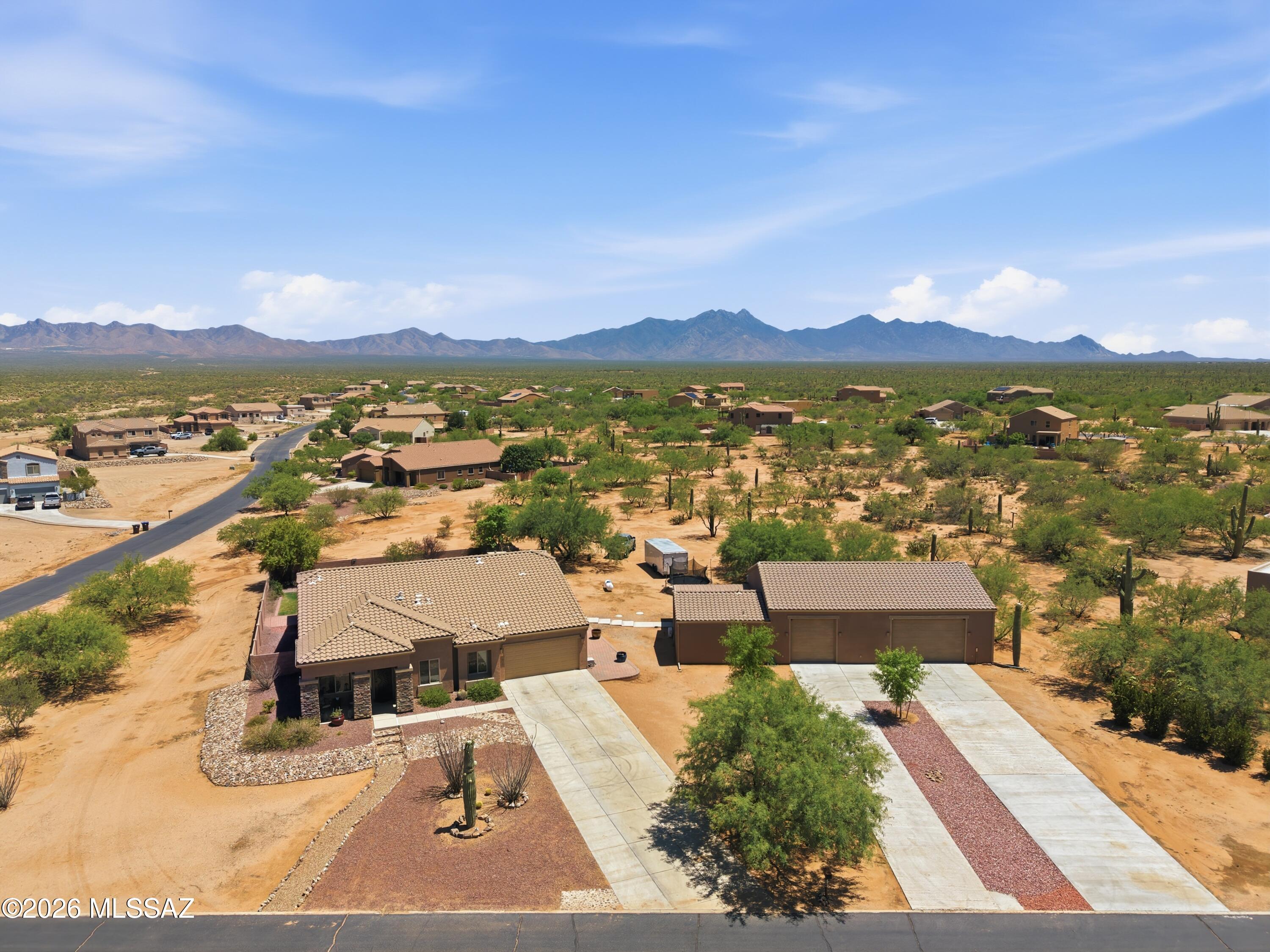 Now positioned at one of the strongest values for acreage + casita + shop space in Southern Arizona! A rare find in Sahuarita Highlands! This private 1.78-acre corner property combines a 2,901 sq. ft. single-story home, a 440 sq. ft. attached casita with its own entrance, and a large detached garage/shop--perfect for multigenerational living, guests, hobbies, car collections, RV/toy storage, a home office, or simply having more room to spread out.
Inside, the split-bedroom floor plan offers a front living room, spacious great room, and a well-equipped gourmet kitchen with gas cooktop, double ovens, commercial-size refrigerator/freezer, dual pantries, and a convenient half bath, a one of a kind option in the area. Outside, enjoy real grass, a built-in BBQ, wood-fired pizza oven, incredible privacy, and beautiful mountain, sunrise, and sunset views.
With a casita, shop, acreage, and flexible living space all in one property, this is the kind of home that's hard to find in a typical subdivision.