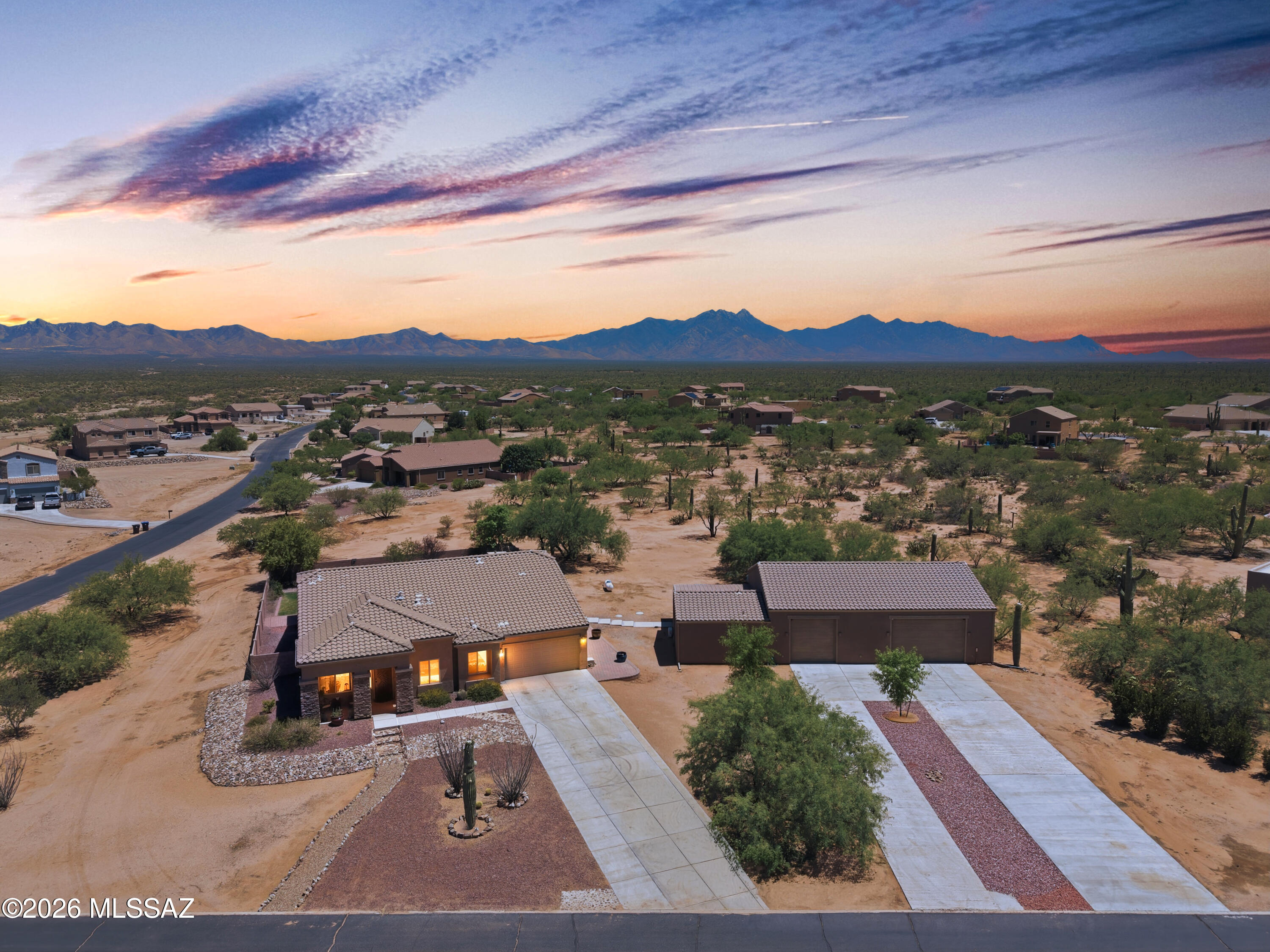 Welcome to your private desert retreat in the highly sought-after Sahuarita Highlands! Situated on an expansive 1.7+ acre corner lot, this property offers mountain views in every direction, along with stunning Arizona sunrises and sunsets that can be enjoyed from nearly every outdoor living space. The main residence features 2,901 square feet of thoughtfully designed single-story living, complemented by a detached garage/shop and a 440-square-foot attached casita complete with its own private entrance--perfect for guests, multigenerational living, a home office, or hobby space.
Inside, you'll find a highly desirable split-bedroom floor plan with an inviting front living room that flows into the spacious open-concept great room and gourmet kitchen. Designed for those who love to cook and entertain, the kitchen is uniquely equipped with propane service, a gas cooktop, double ovens, a commercial-size refrigerator freezer combo, and dual pantry closets providing exceptional storage and functionality. Exclusive to this floor plan, a conveniently located half bath adds additional comfort for guests.
Step outside and discover an outdoor oasis designed for enjoying Southern Arizona living. The expansive backyard features lush real grass, a built-in BBQ area, and your very own wood-fired pizza oven, creating the perfect setting for entertaining family and friends while taking in amazing views and spectacular desert skies.
With room to roam, incredible privacy, a detached garage/shop, guest casita, propane amenities, on a spacious corner lot, this property offers a rare combination, a one-of-a-kind property you won't want to miss.