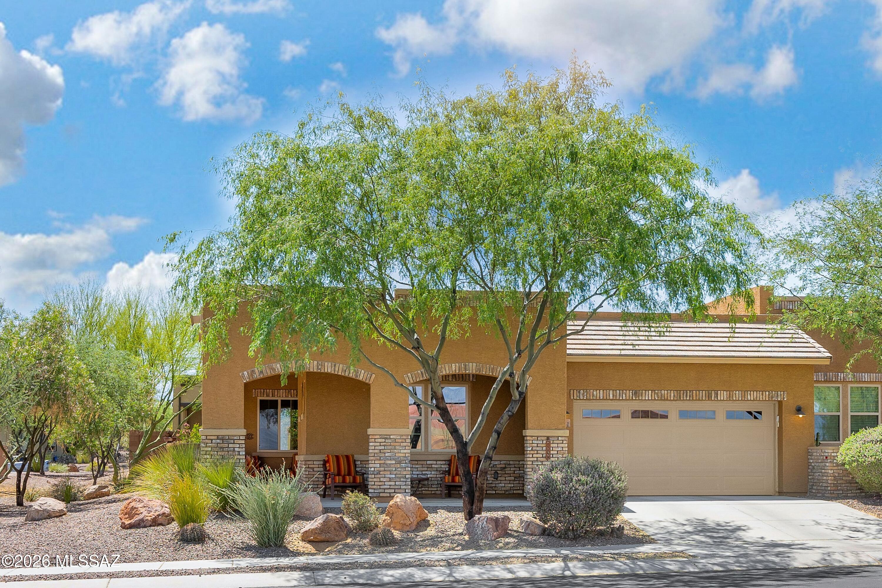 Two Bedroom, Two Bathroom townhome positioned within Ridgeview gated community on an interior lot, this home offers a sense of space and light not often found. With only one adjoining neighbor it has a more open, airy feel. A wraparound front porch invites slow mornings--sunrise, mountain views, and a quiet moment to begin the day. Just across from the community pool and spa, the location balances ease with livability. Inside, the home unfolds around an expanded island, athe natural center--designed for gathering, conversation, and everyday living, and distinct within the community. KitchenAid stainless appliances include a built-in convection oven and gas 5-burner range, complemented by a 2025 LG refrigerator, Kashmir cream granite, upgraded cabinetry, and a walk-in pantry. Custom Wood Interior Shutters throughout.  Ceramic tile flooring carries through the main living areas, with carpet only in the primary suite, which offers a walk-in shower with dual shower heads.
Outdoor living is equally considered, with hand-laid pavers, mature various fruit trees, an extended covered patio, and custom electric sun screens creating a flexible indoor-outdoor environment. Additional highlights include a custom wrought iron security door, spacious laundry room with sink and cabinetry, garage storage solutions, and a roof recoated in 2024. Turn-key option available.