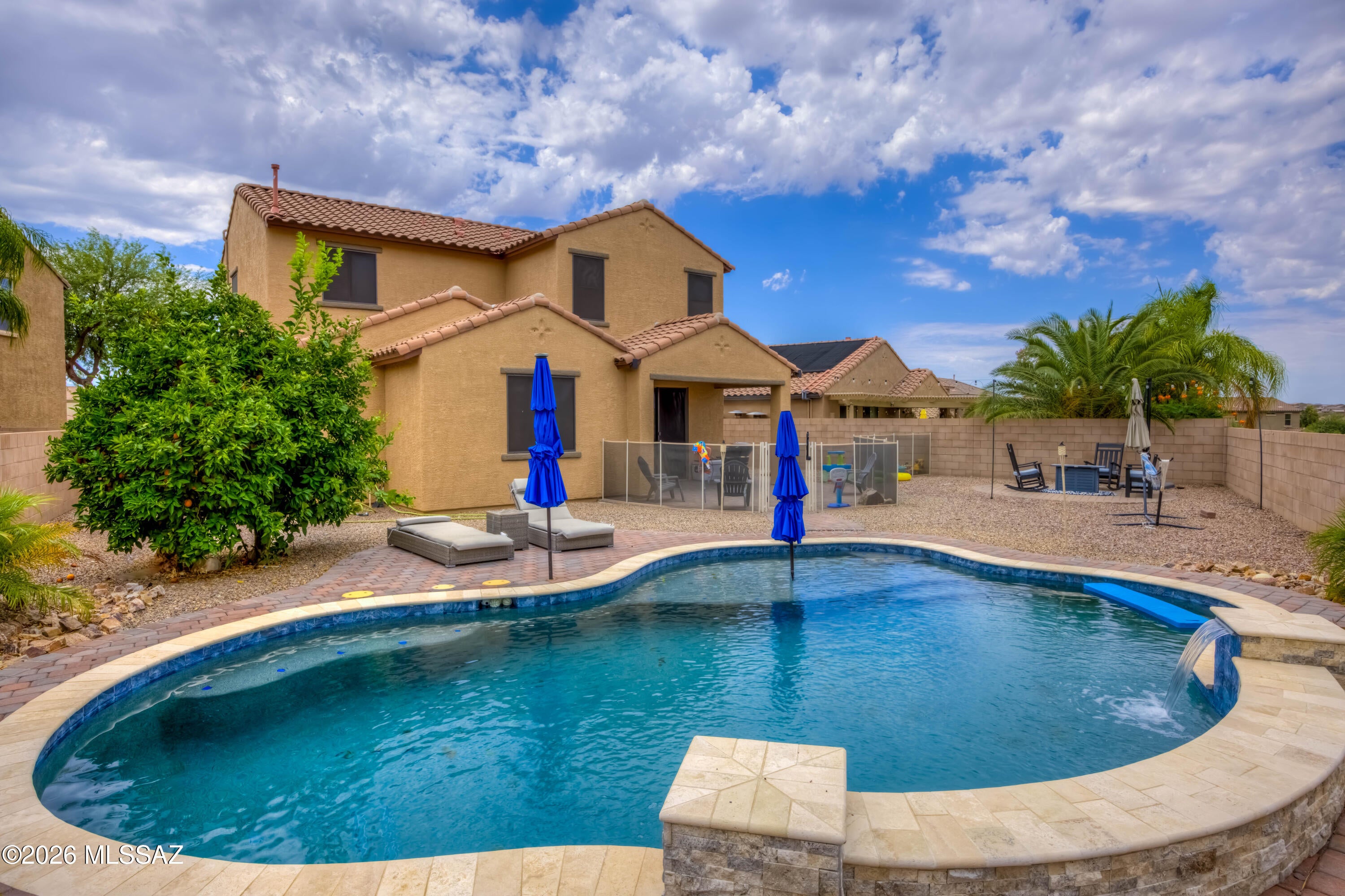 Enjoy all of the upgrades with a fantastic view in this inviting Vail home. Nestled in the back of Rancho Del Lago, this home looks over a natural desert common area  and foothills for views year-round. A sparkling pool and beautifully landscaped backyard are only the beginning here, with tons of upgrades and custom touches throughout. 3 bedrooms and 3 bathrooms are comfortably set in 2,200 sf including a separate living room, family room and dining room. A refined kitchen with white antique glazed cabinets and a spacious island are perfect for entertaining. Down the hall, a custom-built bookcase hides the entrance to your personal movie room. Upstairs a full bath joins the 3 bedrooms and the laundry room. There's too many features to list - plus an assumable VA loan - come see it today!