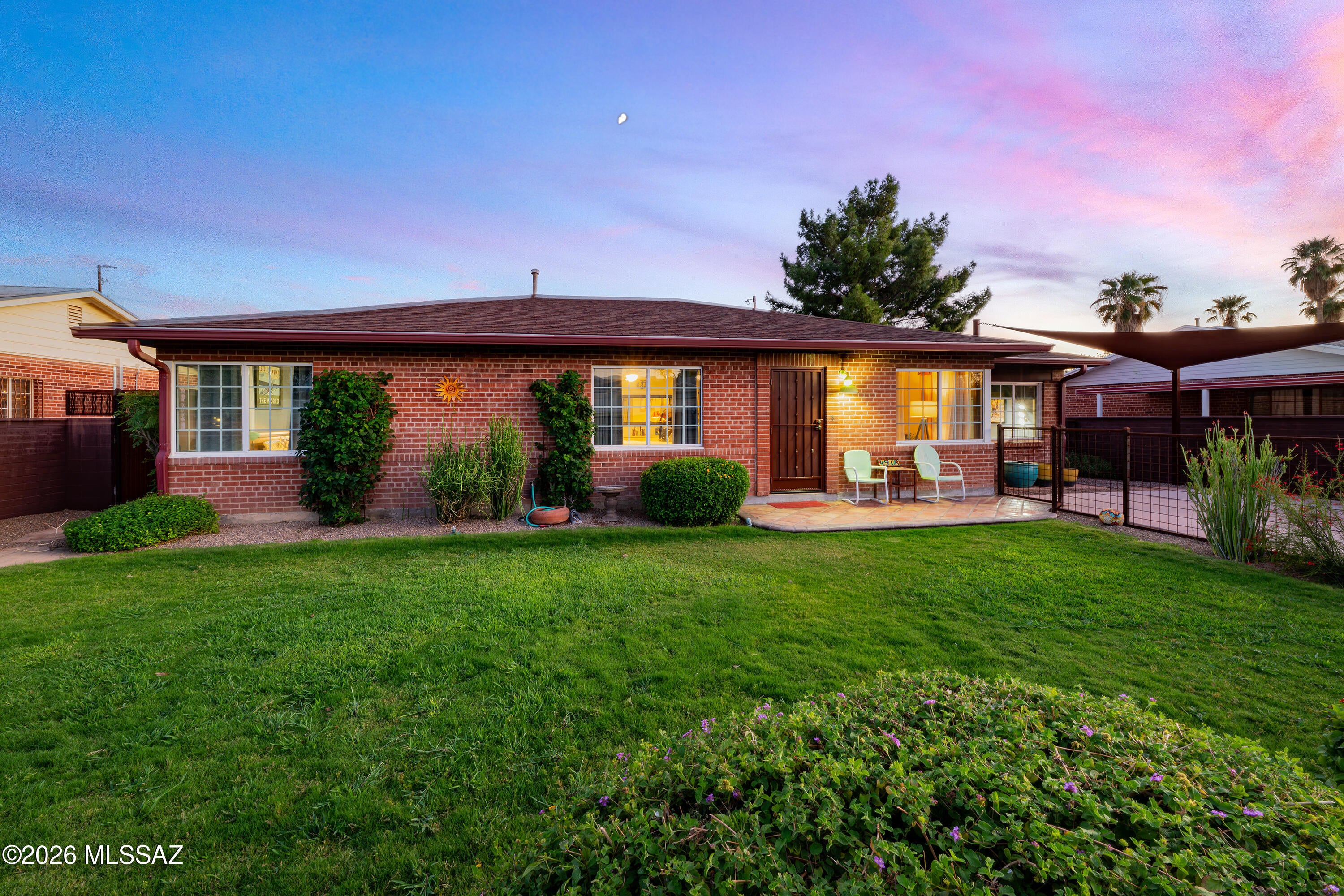Charming 1949 Central Tucson Red Brick Bungalow - Lovingly Maintained & Beautifully Updated! Long-time ownership and thoughtful improvements shine throughout this inviting 2,058 sq. ft. home, offering a flexible split-floor plan with 4 bedrooms, 2 bathrooms, a bonus room, and a spacious Arizona/family room, along with multiple living areas. Original character blends beautifully with functional updates, creating a warm and comfortable home ready for its next chapter.
Set on a large, walled lot, the property welcomes you with a charming gated front courtyard, landscaped grounds with mature vegetation, and ample covered parking. The extended backyard is designed for both relaxation and entertaining, featuring newer fencing, a double gate, multiple covered patio areas, rainwater storage, and a spacious storage shed/workshop.
Inside, you'll find a remodeled kitchen with breakfast bar, updated bathrooms, newer bedroom carpeting, newer ceiling fans and light fixtures, and newer Saltillo tile. The Arizona/family room provides additional flexible living space and connects to the outdoor areas, while the bonus room offers another opportunity for an office, hobby room, guest space, or whatever suits your needs. Additional improvements include a newer roof, gutters, front security screen door, parking sunshade, and extensive landscaping and yard improvements.
Just steps from Hoffman Park, with its walking path, play areas, and lush vegetation, and Bike Blvd, this special Central Tucson property offers a wonderful blend of historic charm, flexible living spaces, and inviting outdoor areas, all in a convenient location close to the many amenities Tucson has to offer.