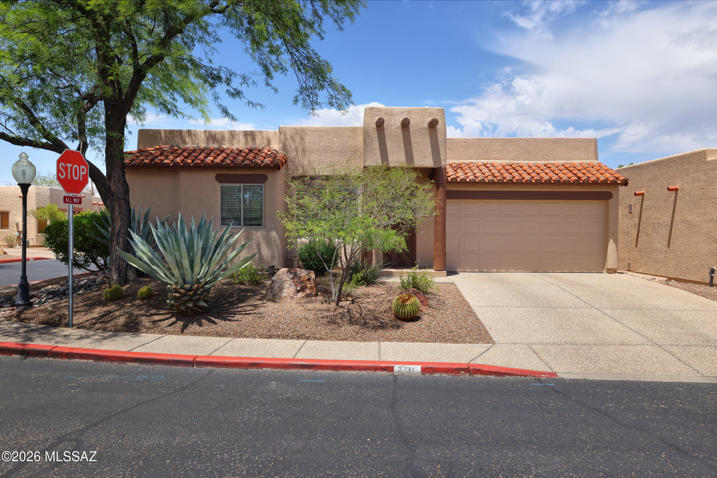 Conveniently located minutes from U of A, Banner Hospital, and shopping sits this special home.  In a small community boasting 24 hour video surveillance, sidewalks, community pool and loads of guest parking.  Newly renovated, w/luxurious high end finishes, this home offers diagonally scored colored concrete floors, beautiful granite counters in the kitchen & 2 bathrooms + an abundance of windows & sliders to enhance the light & open feeling.  A gas fireplace adds character to the living space.  The kitchen features SS appliances, gas cooking & a pantry.  The split bedroom plan provides privacy for the master bedroom featuring slider access to the rear yard, walk-in closet, dual vanity sinks + a beautifully tiled floor to ceiling shower.  Privately screened & shaded rear yard, turf + ++.