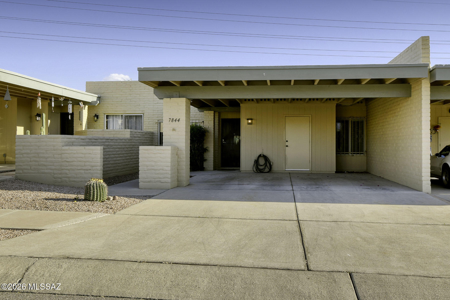 Move-in ready, freshly painted & beautifully updated 2 bedroom/2 bath TH in a great location! The bright kitchen has a breakfast area, new counters, Energy Star stove and GE appliances. Open to the living room w/ new sliding glass doors that lead to the enclosed back porch. All windows and interior doors have been upgraded. The bathrooms each have new vanities, with a walk in shower in the primary bath and shower/tub in the guest bath. The bedrooms are spacious with roomy closets and there is stylish easy care poured concrete flooring throughout the home. Enjoy privacy off the enclosed back porch with desert growth creating natural screening beyond the solid block wall. The roof is recently re-coated. The 2 car carport has extra enclosed storage space. There are 2 community pools and a tennis court.