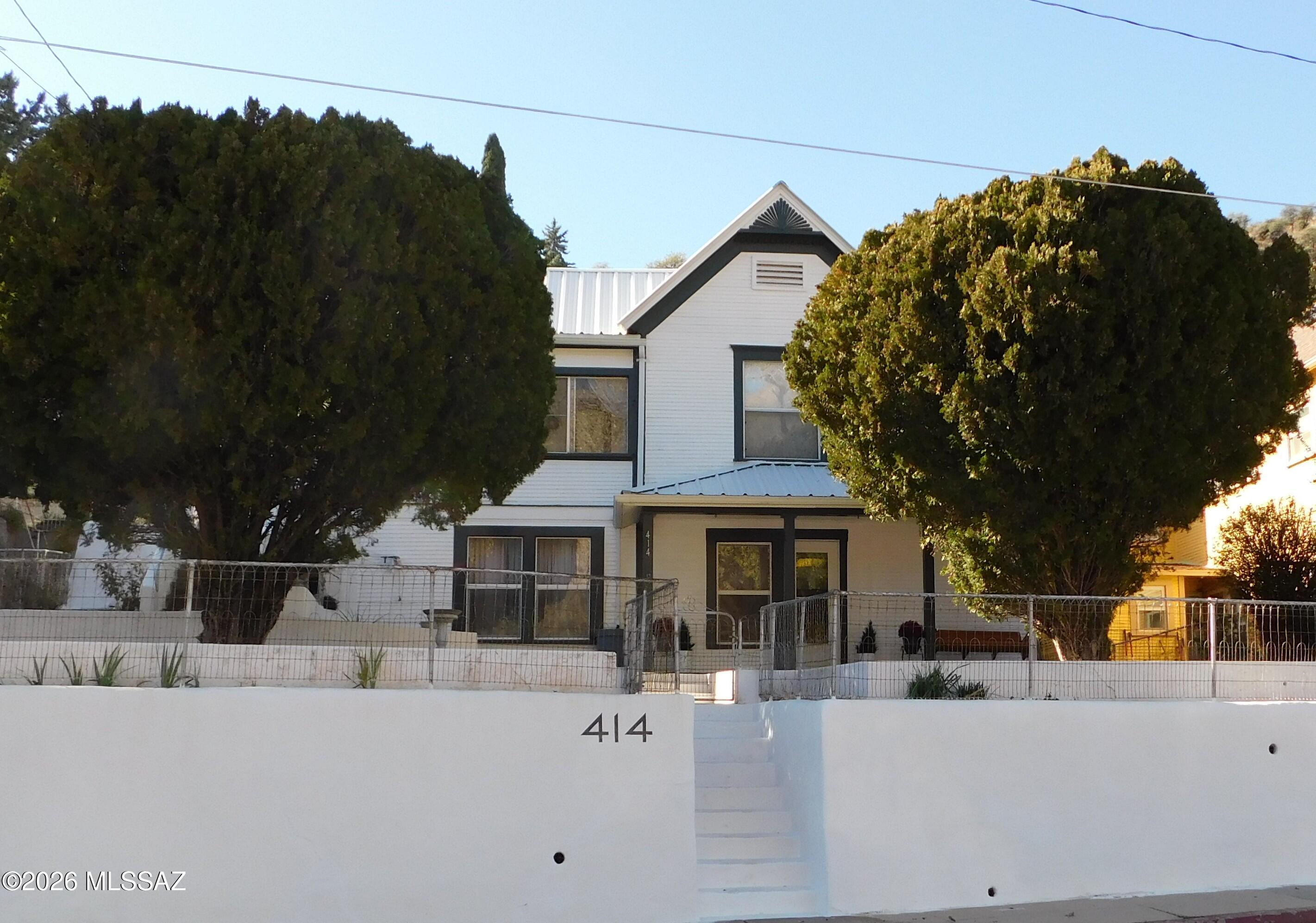 Step Back in Time with This 1905 Bisbee Beauty with Views that'll Steal Your Heart! This exceptional SOLID historic 1905 two-story residence, located in the heart of Old Bisbee, offers approximately 2,550 square feet of versatile living space with superb panoramic views & privacy. A key feature of this property is its excellent potential to function as two separate homes or apartments. The second floor can be easily closed off to create an independent unit with 2+ bedrooms, 1 bathroom, and a full kitchen, while the lower floor provides its own 2-3 bedrooms /1 bathroom with space for a full kitchen - making it ideal for multi-generational living, extended family, or generating rental income in this popular tourist destination. If used as a single-family home, the space is endless...MORE Why You'll Fall Head Over Heels:

4+ Bedrooms & 2 Bathrooms: Plenty of space for family, friends, or that eccentric artist phase you've been dreaming about.
Full-size attic. Large closets and multiple pantry spaces. Several main entrances to choose from, and to help section off the floors if considering turning it into two homes/apartments. PLENTY of parking for those fabulous BBQ's!

Versatile Vibes: Transform the second floor into a separate apartment with its own 2 beds, 1 bath, and kitchen - rental income or in-law suite! Close it off, and voila: two independent homes under one roof. Perfect for multigenerational living or Airbnb gold in touristy Bisbee.

Bonus Fun Zones: A dedicated indoor workshop/creative space for your DIY dreams, and a game room(or extra bedroom/office/2nd living room) that's begging for ping-pong/pool tournaments, movie nights, or whatever shenanigans you cook up.

Outdoor Oasis: Huge front yard - 3-car carport and covered patio with a romantic swing overlooking the mountains and the beautiful colors of Old Bisbee. That's just the start of the magic at this charming 1905 two-story gem - a historic home that's equal parts cozy retreat, adventure pad, and income opportunity! Nestled close to downtown so you or your guests can walk to all that Old Bisbee has to offer without having to get into your car.

This amazing stunner isn't just a house, but a solid foundation for all of your future needs... and nestled within walking distance to downtown, where the vibes are vibrant, and you can enjoy Bisbee's artsy, eccentric spirit.

Whether you're a history buff, a view junkie, or a savvy investor, this property screams "adventure awaits!"

Welcome Home!