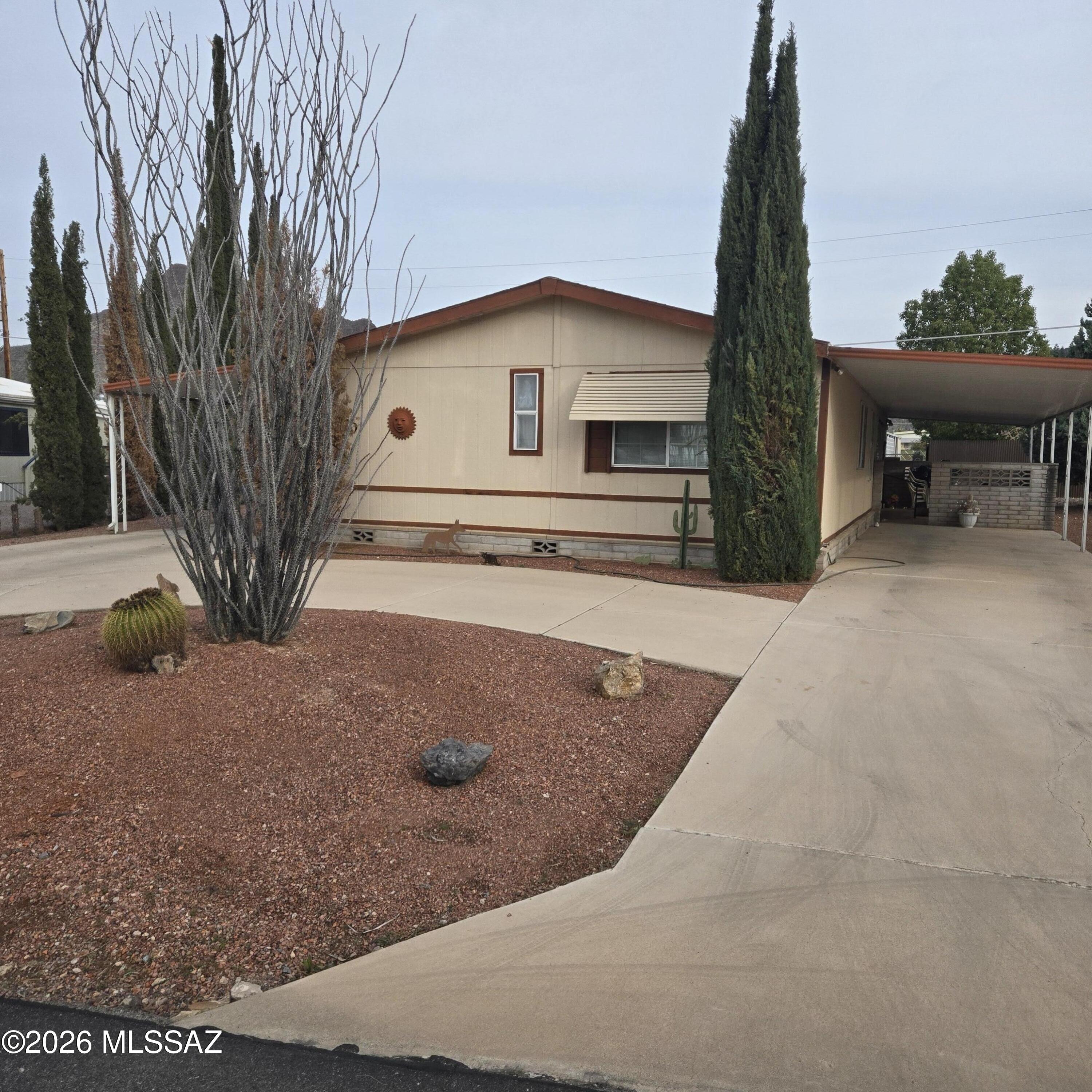 Nestled in a welcoming 55+ community, this furnished home offers a cozy split-bedroom layout with 3 bedrooms and 2 baths. Enjoy a warm, inviting living room, covered patio, roomy lot, and a free-standing workshop. Two carports and a convenient laundry room add comfort. A golf cart is negotiable. Community charm includes 2 pools, hot tub, spa, an 18-hole executive golf course, library, local radio station, and vibrant social activities--perfect for relaxed, connected living. You own the land.