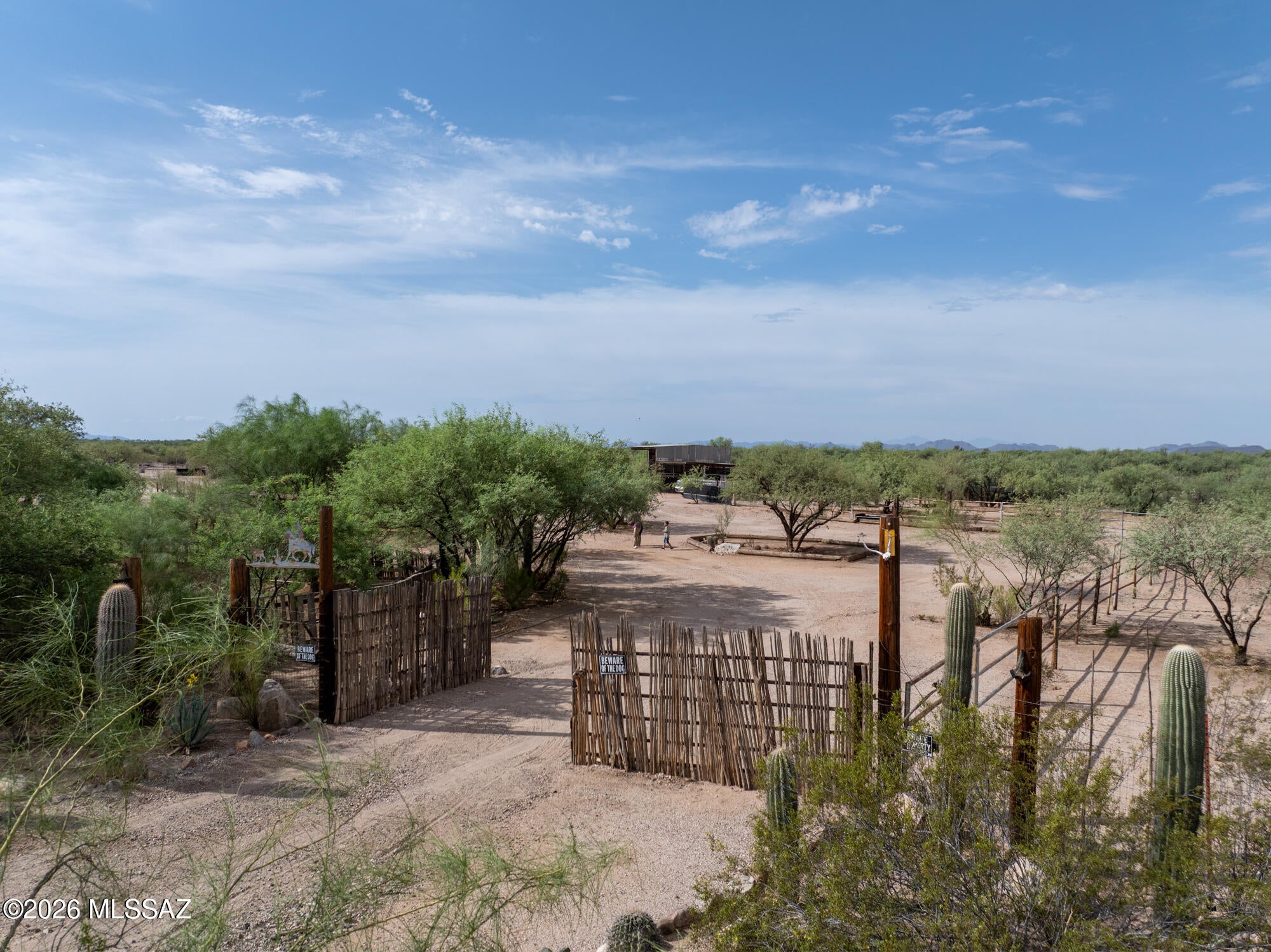 Welcome to Flying X Ranch--your private desert retreat where country living meets endless possibilities! Bring all your animals and toys and enjoy country livin! 

Impressive horse facilities, including a large riding arena, multiple pipe-fenced pens, stalls, alleyways for livestock, a spacious hay barn, tack storage, dog kennels and an inground round pen! 

The acreage showcases the beauty of the Sonoran Desert with mature saguaro cacti and wide-open skies, while a shared well and septic system provide practical rural utilities. Conveniently located just outside of Marana, you'll enjoy the serenity of country living with access to nearby amenities when needed.

4.43 acres is plenty of space to make your equestrian dreams come true!