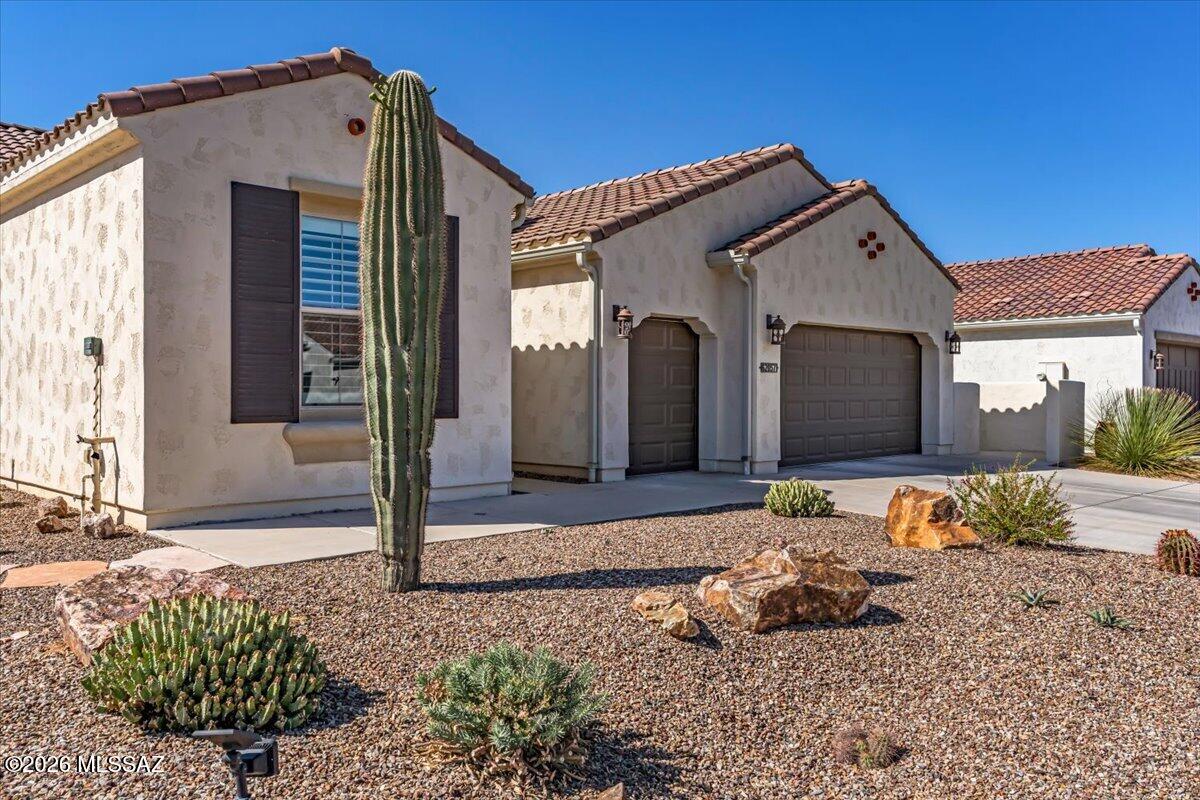 This ever-popular Fresco model in Saddlebrooke Ranch features 2 spacious bedrooms with en-suite baths, a powder room, den with double doors, and separate dining area with built-in buffet cabinetry. Tile flooring throughout, a neutral palette, and 8' shaker-style doors create a clean, modern feel. The kitchen is designed for entertaining with a large island, quartz countertops, gas range, wall oven, and walk-in pantry. Enjoy Arizona living on the covered patio with Cool Decking, rolling sun shades, and an expansive private backyard. The versatile den is ideal for guests, hobbies, or a home office. A laundry room with sink and tons of cabinetry offers a place to maintain tidiness. With views of Mt. Lemmon rounding out the many benefits of this home, it's the perfect place to call home!