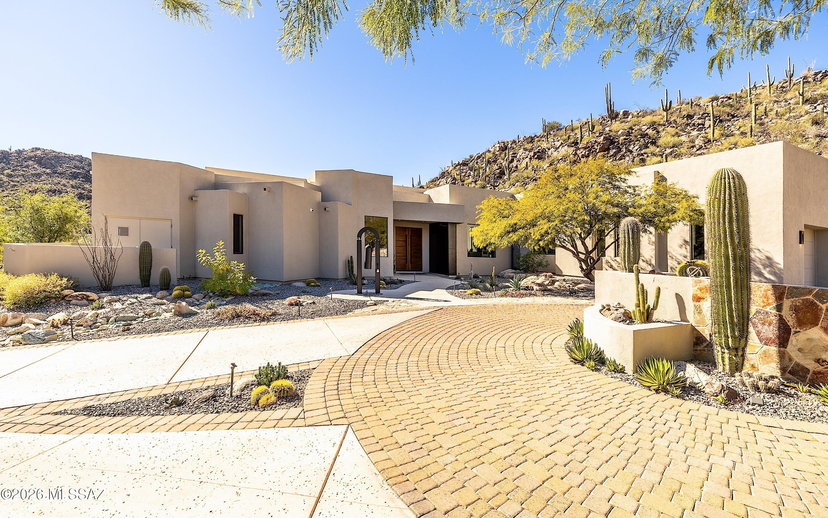 Winner of the ASID 2024 1st Place Remodeled Design Award, this Marc Soloway architecture and Lori Carroll interior masterpiece was stripped to its core and reborn in 2023. More than a renovation, this is a like-new residence featuring brand new mechanicals and custom heated pool. Exquisite walnut doors open to a world of bold modern luxury. Porcelain tile floors flow through an expansive floor plan designed for effortless entertaining. The gourmet kitchen is a culinary showcase with a hidden walk-in pantry, while the great room is anchored by a mesmerizing linear fireplace. Floor-to-ceiling glass provides stunning views and ambient warmth, blurring the line between the tranquil desert and the home's sophisticated finishes. Every detail reflects a perfect union of luxury and simplicity. Owned outright solar is another great feature. Very welcoming driveway appeal -artistically inviting all guests. The residence is a stunning modern/contemporary work of sleek design.
Dove Mountain is a 2025 Readers' Choice contender for Best Master-Planned Community. Enjoy Dove Mountain's world class golfing, outstanding hiking trails, biking paths, state of the art sports club, casual and fine dining options. Easy access to theatre and the arts, University of Arizona campus and multiple airports. Sonoran Desert living at Dove Mountain means enjoying outdoor living at its best. Nearly 1/3rd of Dove Mountain's 6,200 acres of desert splendor is being kept in perpetuity as natural open space. That lovely "cooing" sound you hear in the evenings may be the gentle Inca Doves which live in the area and give this elegant enclave its name. Pima County's 3,000-acre Tortolita Mountain Park borders Dove Mountain to the north. To the south is the 2,400-acre Tortolita Preserve, with its outstanding biking and hiking trails, designated to be permanently sustained by the City of Marana and the State of Arizona. Nestled in the beautiful Tortolita Mountain Foothills, Dove Mountain is perhaps the epitome of Southwest desert living. The temperate climate allows residents to enjoy an indoor/outdoor lifestyle virtually all year-round, not just in in the fall, winter and spring seasons for which the region is famous. The wildlife of Dove Mountain is fascinating. The Sonoran Desert is home to species like the Great Horned Owl, the Golden Eagle, the Black-chinned Hummingbird, Gambel's Quail, the Hooded Oriole and the Cactus Wren, Arizona's official bird. The lifestyle here is fascinating, mesmerizing, graceful, luxurious, peaceful and fun.Perhaps your own Dove Mountain story is just beginning at THIS lovely, fine custom home. Call for a private showing.