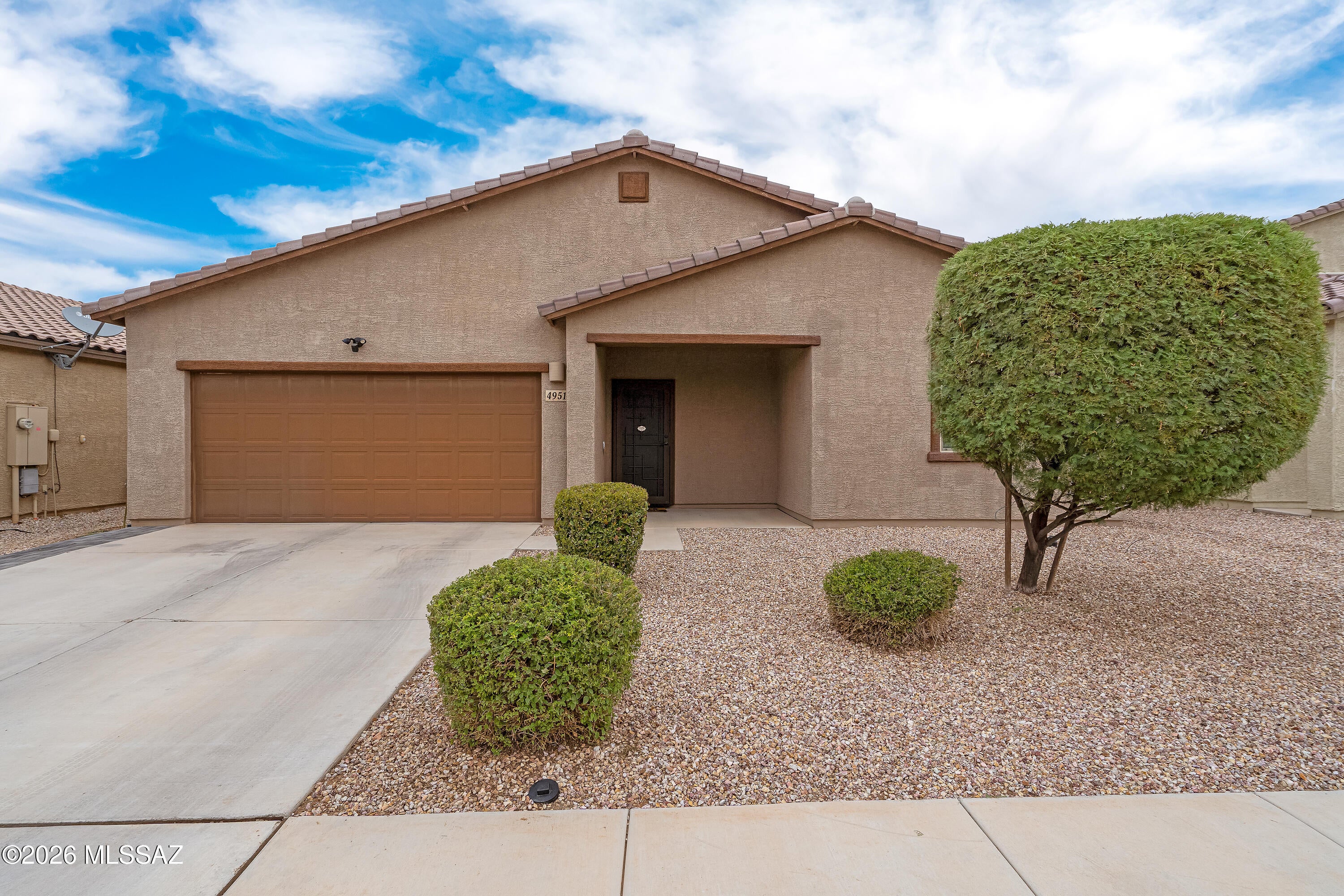 Welcome home to this immaculate 2021-built contemporary in Valencia Crossing! This single-story 4BR/2BA offers 1,852 SF of thoughtfully designed living space, anchored by a great room and a chef-ready kitchen with granite counters, gas range, walk-in pantry, and reverse osmosis system. Retreat to the primary suite with a walk-in closet and double-vanity bath. Step outside to a covered paver patio framed by low-maintenance desert landscaping and mountain views. A 3-car garage, smart thermostat, and Energy Star windows add everyday convenience. Sidewalks, a park, and a basketball court are just steps away. Don't miss this move-in-ready gem!