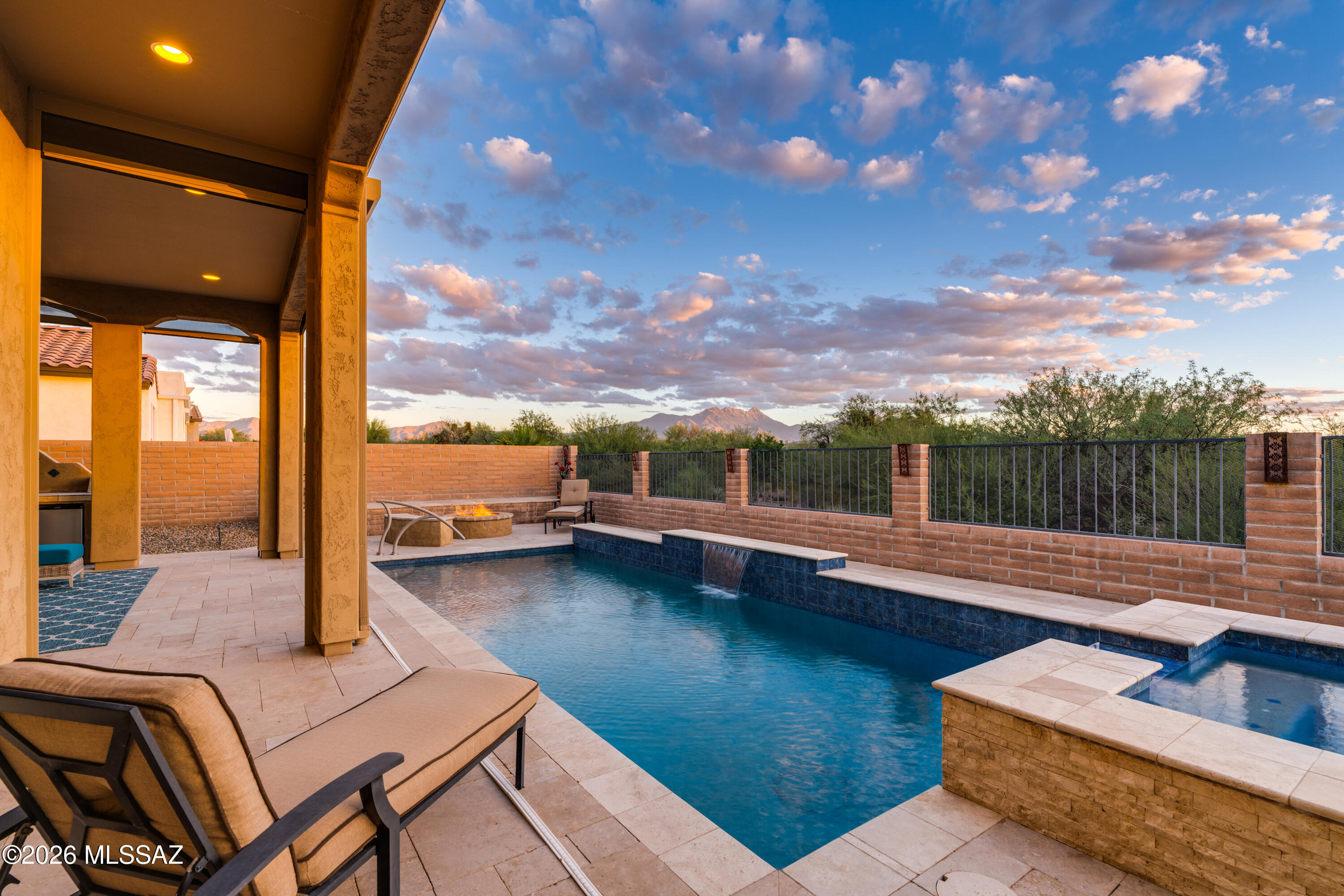 This spectacular home on sought-after Madera Plateau in Quail Creek resort community borders lush, desert arroyo and offers stunning views of the Santa Rita Mountains -- VIEWS THAT WILL NOT BE OBSTRUCTED BY FUTURE NEW CONSTRUCTION! You'll enjoy outdoor living at its finest with a refreshing pebble sheen pool and spa surrounded by travertine pavers, outdoor kitchen, fire pit and extended covered patios. This popular Sonata model has 4 BR Suites (including the casita, all with en suite baths) plus a Den and powder room. Gorgeous curb appeal w/ gated front courtyard, and glass paneled entry door. Foyer leads to the great room, anchored by gas fireplace and soaring 12' ceiling. Kitchen has a grand island w/ granite counters, upgraded cabinets, stainless appliances, and 36'' gas cooktop. Full wet bar off the dining area with storage and beverage coolers. Spacious owner's Suite has box bay window and exit to rear patio. The main bath has dual vanity, all-tile shower, and huge walk-in closet w/ custom built-ins and doors at both ends, offering easy access to the laundry. Bedroom 2 in the main house has an en suite bath w/ tub/shower combo. Bedroom 3 has built-in wall unit, for use as an option second office, and includes an attached full bath w/ tile shower. Plus there's a separate Den off the foyer, separate powder room, and laundry with added storage. Step out to the front courtyard to the private entry Casita, where overnight guests will enjoy luxury accommodations, complete with a kitchenette and full en-suite bath and tile shower. Back outside, the outdoor living space is a sanctuary of its own, with jaw dropping mountain views, awe-inspiring sunsets and pristine desert surroundings. Rear patio includes electronic shades. Extended length garage with golf cart bay and side service door. This home is the unicorn you've been waiting for!