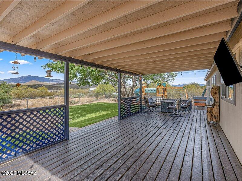 SELLER CREDIT TOWARDS BUYER CLOSING COSTS AND/OR INTEREST RATE BUYDOWN WITH ACCEPTABLE OFFER! Rare opportunity in this area! This 2,560 sq. ft. home features 4 bedrooms, 2 bathrooms, and open-concept living on a spacious .98-acre lot with panoramic Rincon Mountain views. The kitchen, dining, and family room flow seamlessly for comfortable everyday living and entertaining. Enjoy a large rear deck and fenced backyard with a paver patio, low-maintenance synthetic turf, and a drywalled storage shed with windows--ideal for hobbies or extra storage. The backyard also includes hot tub power hookups for a future spa retreat. A separate side yard offers ample space for RV parking, boats, trailers, or recreational storage. Backyard playset conveys. Agent is related to seller.