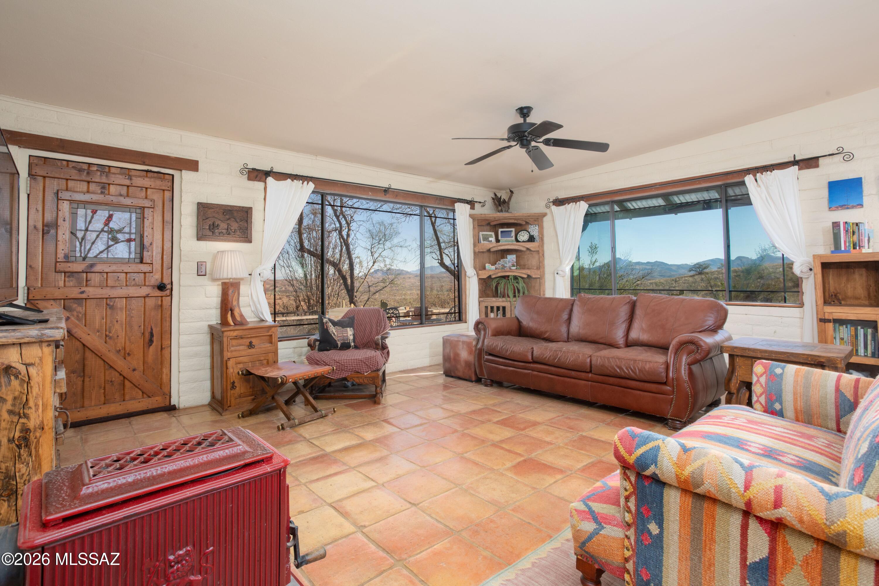 Recently  APPRAISED ABOVE ASKING price! A Southwest lovers dream!  This unique, custom built home sits atop a hill with expansive views on 5 acres of high Sonoran desert.  The property is easily accessed by a 3 mile, privately maintained dirt road and sits across the street from thousands of acres of the Coronado National Park, ensuring your ultimate privacy and unlimited views.  While feeling remote, you are just a 5 minute drive to the town of Arivaca and the Buenos Aires National Wildlife Refuge.  This uniquely Southwestern home features saltillo tile floors, Mexican tile counters and accents, custom kitchen cabinets with punched metal inserts and four custom stain-glassed windows featuring birds of the area.  Enjoy your views from the spacious living area with ample windows or from the large covered patio. Slip away to the privacy of your primary suite with its own fireplace and en suite. A 629 foot outbuilding/casita, recently upgraded with a new roof, windows and paint, can be used as an office, gym, artist's studio, etc.  The main house has a new HVAC unit and new washer/dryer units that stay with the property.  Welcome home to your desert oasis!