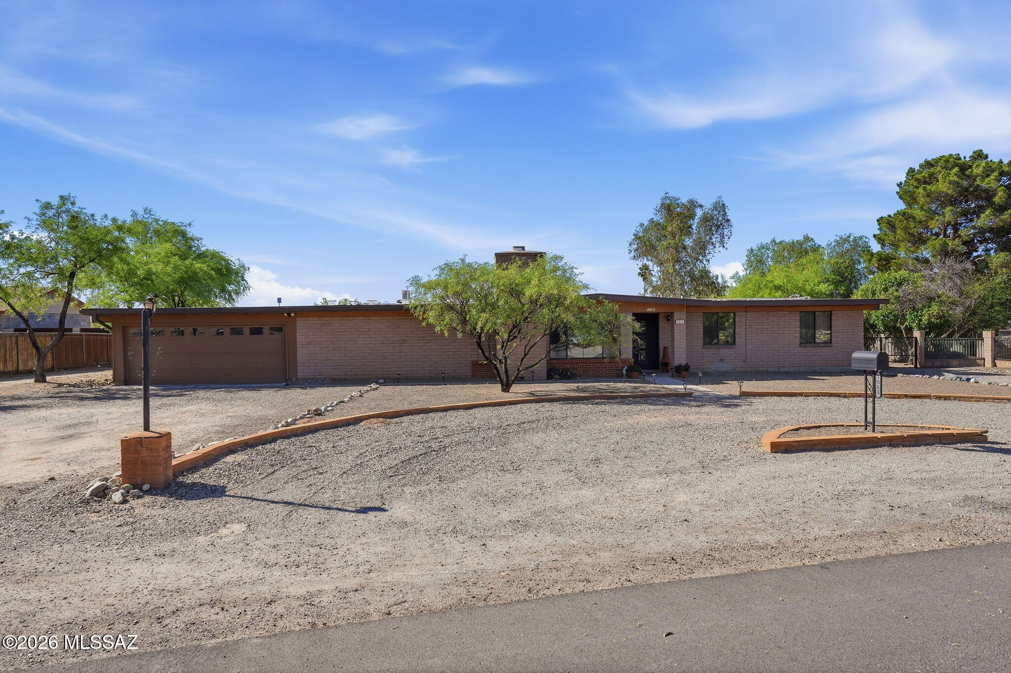 Beautifully updated home on nearly an acre with no HOA! This property offers space, privacy, and style throughout. The kitchen is a showstopper with quartz countertops, a generous island, induction cooktop, and high-end Cafe appliances. Enjoy the comfort of luxury vinyl tile flooring, updated bathrooms, and a spacious media room perfect for entertaining. A large, privately fenced guest suite (fully permitted) provides versatility for extended family or visitors. The 4-car garage and 2-car carport offer ample parking and storage, while the expansive lot has room for all your toys, hobbies, and outdoor fun. Plenty of room to add a pool!  This exceptional home combines modern updates, functionality, and freedom -- ready for you to move in and make it your own!