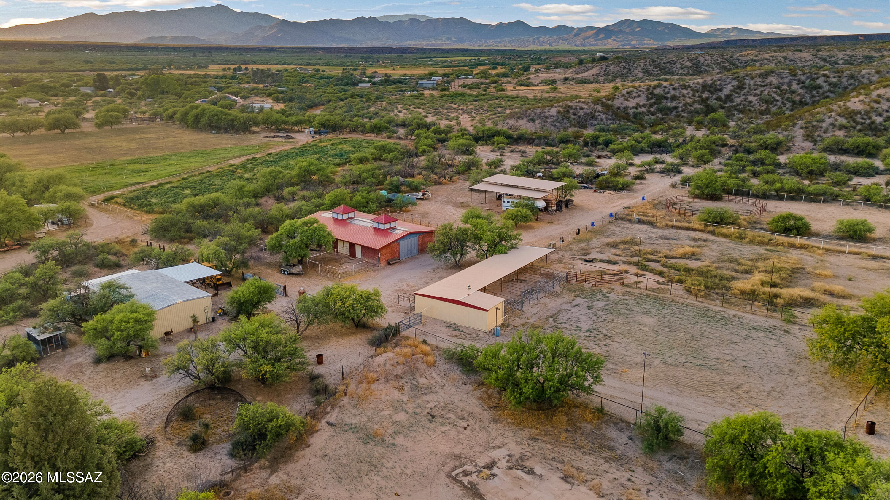 Welcome to an extraordinary opportunity in the serene countryside of Pomerene Park in Benson, Arizona-where wide-open skies, peaceful desert landscapes, and endless potential come together on this remarkable 8.33-acre estate. This rare offering is truly a one-of-a-kind property designed for those seeking space, versatility, and the ultimate rural lifestyle, whether for full-time living, equestrian pursuits, or a private weekend retreat. As you arrive, you're immediately greeted by a long, private approach enhanced by a substantial straw bale wall with a stucco finsh along Pomerene Road-fully
paved-providing both privacy and a sense of arrival. Beyond the entrance, the property unfolds into a beautifully maintained desert oasis that perfectly balances convenience with seclusion. Despite its tranquil setting, you just minutes from the heart of Benson and approximately 45 minutes from Tucson, making it an ideal blend of rural charm and accessibility. The property features two separate living quarters, offering flexibility for multi-generational living, rental income, or a dedicated caretaker setup. The main residence welcomes you with recent upgrades, including a newer metal roof, and provides a comfortable living space ready to enjoy or expand upon. The guest house spans approximately 1,100 square feet and includes 2 bedrooms and 1 bathroom--perfect for extended family, guests, or on-site help. Equestrian enthusiasts will immediately recognize the exceptional value in the extensive horse facilities already in place. The property boasts an impressive 8-stall barn with runs, a large tack room, and abundant storage for feed and equipment. Additional stalls with larger turnouts provide ample space for horses to roam comfortably, benefits include a riding arena along with a round pen for your horses. Not to mention, you will be provided with plentiful storage with two hay barns. The barn carries indoor and outdoor wash racks for easy accessible cleaning. With miles of scenic riding trails nearby, this property is truly a dream for horse lovers. Adding to its functionality, a generously sized shop provides substantial workspace with both electricity and water already in place--ideal for hobbies, equipment storage, or business use. There is also covered RV parking, ensuring your recreational vehicles, trailers, and toys are well-protected from the Arizona sun. Plenty of opportunities with two RV Hookups for any additional living quarters. One of the standout features of this property is the peaceful private pond, creating a unique and tranquil outdoor setting rarely found in the area. Whether you're enjoying quiet mornings or hosting gatherings under the Arizona sky, this feature enhances the property's natural beauty and livability. The land itself consists of four parcels being conveyed, offering flexibility for future development or expansion. For those seeking even more space, the sellers are open to offering an additional nearly 30 acres at a separate price--creating an incredible opportunity to build out a larger ranch, compound, or investment property. Utilities are thoughtfully set up with propane gas connections servicing the homes and barn, and both the main house and barn have recently been upgraded with durable metal roofing--adding long-term value and peace of mind. This property is more than just land--it's a lifestyle. Whether you envision building your dream home, creating a fully operational horse property, or simply enjoying the quiet beauty of Southern Arizona, the possibilities here are truly endless. Opportunities like this--combining acreage, infrastructure, and location--are rare to find. Experience the cooler temperatures of Benson, the beauty of the high desert, and the freedom that comes with wide-open space--all while remaining within reach of modern conveniences. Don't miss your chance to own this exceptional property--schedule your private showing today and discover everything this incredible Pomerene Park estate has to offer.