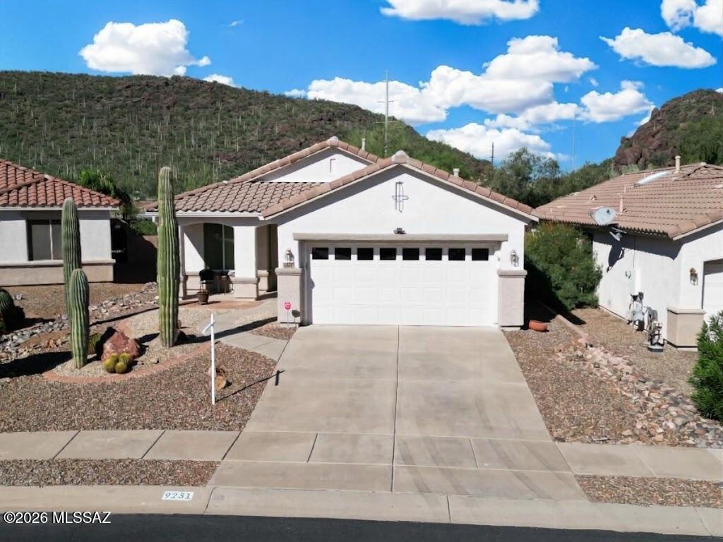 Nestled in a corner setting within Sunflower, this move-in-ready Sierra model offers stunning, unobstructed backyard views of Rattlesnake Ridge. Positioned directly across from Rattlesnake Ridge, the home provides an ideal backdrop for breathtaking sunsets--enjoy them from the patio in the beautifully groomed backyard.  After sunset, relax around the outdoor gas firepit. Inside, you'll find a two-bedroom, two-bath floor plan featuring a functional kitchen open to the dining area and great room which is highlighted by a charming fireplace. Plantation shutters add a refined finishing touch throughout. 
Additional highlights include a recently replaced HVAC system with 90% efficiency, and owned solar. Perfectly located near the El Rio Preserve at Los Mortero Conservation Area.