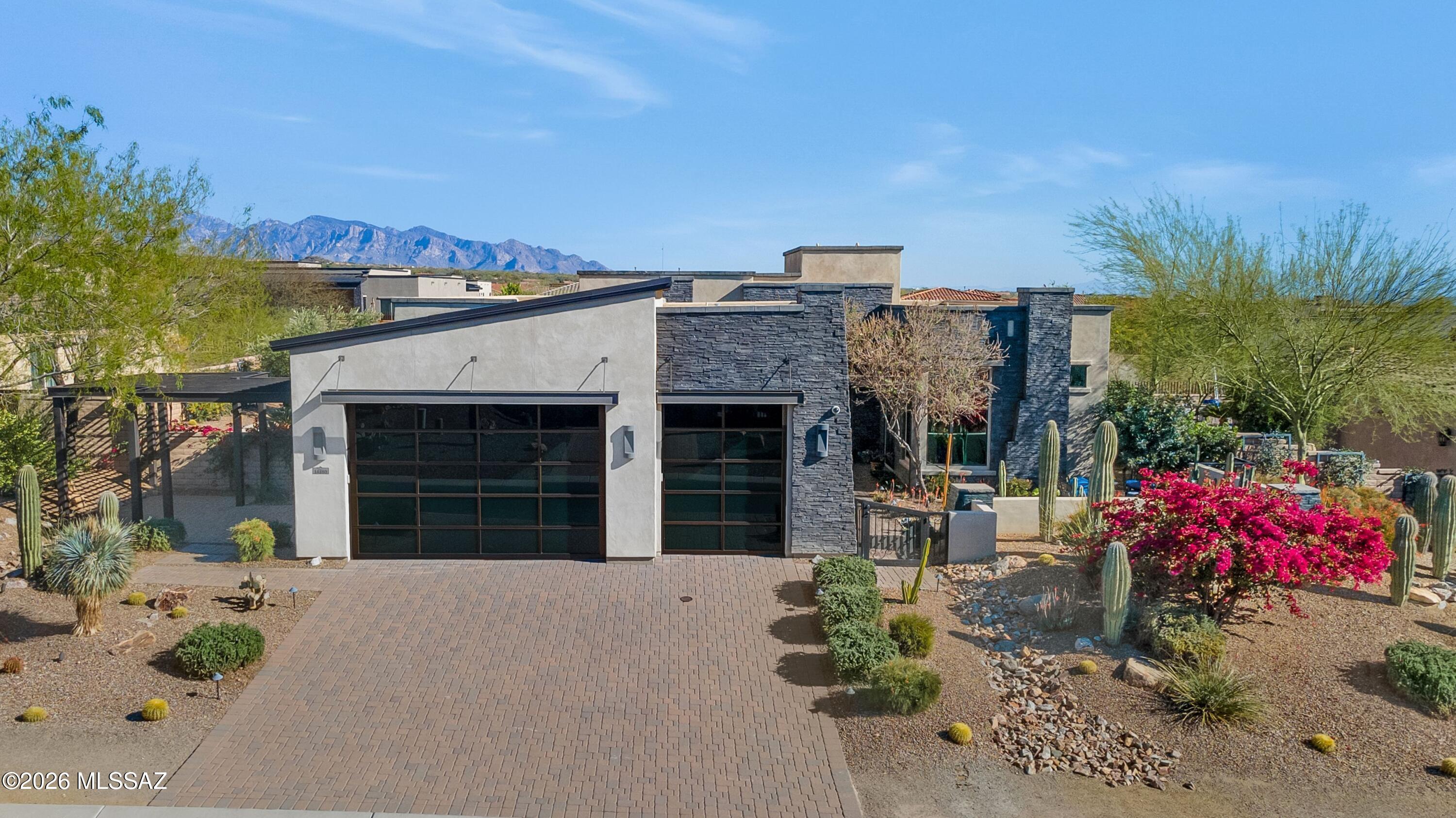 Former Model Home in the Heart of Dove Mountain! 

This highly upgraded residence showcases a spacious and thoughtfully designed floor plan, featuring a desirable split-bedroom layout, a versatile den ideal for a home office or flex space and luxury finishes throughout. Premium materials and designer details create an effortless blend of comfort and sophistication. 

A dramatic wall of windows fill the main living space with natural light and creates a seamless connection to the outdoors, enhancing the home's indoor-outdoor lifestyle. Enjoy a sparkling pool & spa in the resort-style backyard, complete with multiple gathering spaces, a putting green, fire feature & more! Ideally situated in one of Southern Arizona's premier luxury communities, residents enjoy close proximity to world-class golf, hiking trails, dining and The Ritz-Carlton, Dove Mountain. Welcome Home!