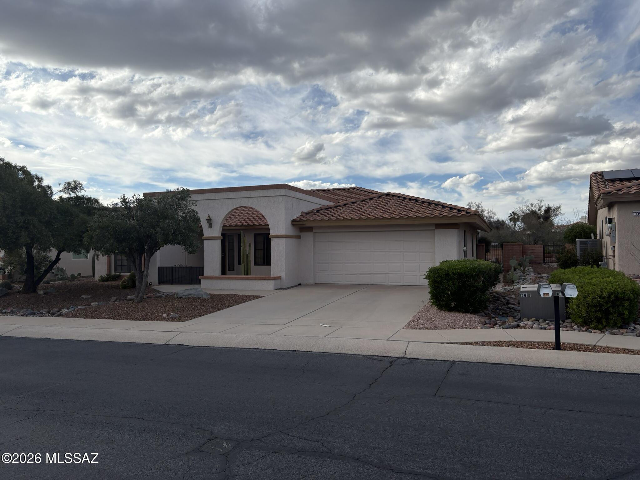 Rare Pacifica Model in the heart of Sun City Oro Valley, a premier 55+ active adult community, showcasing golf course and mountain views. This bright 2BR/2BA home offers 1,750 sq ft of single-level living with vaulted ceilings, expansive windows, and an open, airy layout. Spacious living and dining areas feature a brick fireplace and built-ins. Kitchen includes laminate countertops, oak cabinetry, gas range, stainless refrigerator, pantry, and sunny eat-in nook. Office with built-ins adds flexibility for hobbies or workspace. Generous primary suite with backyard views, indoor laundry, covered patios ideal for entertaining, above-ground hot tub, wrought iron view fencing, 2-car garage, private courtyard entry & whole-house water filtration.
Priced to sell and ready for your personal touch!