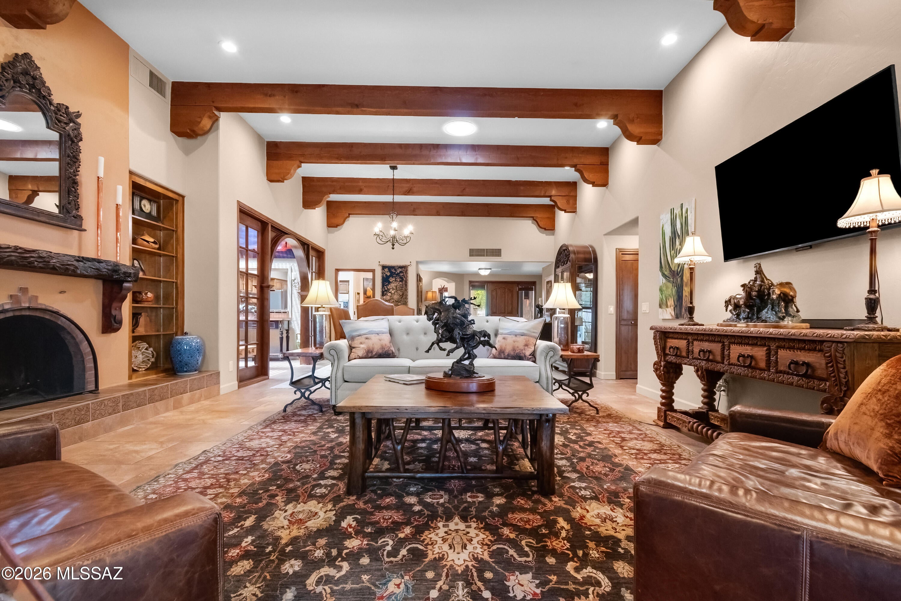 Impeccably updated 3 bedroom, 3 bath, + Den. Located in the beautiful gated San Miquel enclave of 40 homes. 1 Level Masonry/Stucco construction by David Baird. Offered as Turnkey with high end curated furniture by Layne Wade Designs! Private backyard including large covered Veranda and putting green.  Huge great room and dining with 12' ceilings,  beautiful handcrafted beams, and fireplace for true Hacienda living. Anderson Windows, French Doors onto Veranda from Living and Primary bedroom. Spacious gourmet Kitchen includes large Island, breakfast area with large windows, walk-in pantry, and skylight. Community includes pool, spa, tennis & pickle ball courts. Minutes to Whole Foods, Trader Joes, TMC Hospital,  and endless dining options. This home and location has it all. Curated furniture includes pieces from Theodore Alexander, Jason Scott, Restoration Hardware, Century, and other fine furnishings. Seller will consider offers without furnishings.