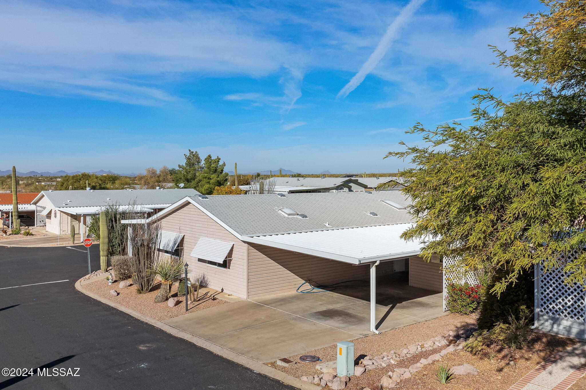 Welcome to this inviting 3-bed, 2-bath home in the popular 55+ community of Copper Crest. Situated on a spacious corner lot with mountain views, this home features a split floor plan and new window treatments throughout. New roof and existing HVAC overhauled in March 2025! Enjoy the newly remodeled kitchen, new vinyl flooring in the main living area, and peace of mind with replaced plumbing—no poly pipes. The lot offers golf cart access, covered parking, and an oversized storage shed/workshop. Start your mornings in the breakfast nook with scenic views, and make the flexible-use room your dining space, office, or additional living area. The master suite is a tranquil retreat, featuring an ensuite bathroom complete with walk-in shower and dual vanity. The two additional bedrooms are well-sized and share a full guest bathroom. All poly piping throughout the home has been replaced.

Outside, you'll enjoy the low-maintenance exterior, perfect for relaxing or entertaining with multiple patios and mountain views. The property also includes a 2-car carport, additional golf cart parking spot and a large, separate storage shed that could double as a workshop.

Residents of Copper Crest enjoy access to a wealth of amenities, including a sparkling pool and spa, shuffleboard courts, and a clubhouse that hosts a variety of community events year-round. This active adult community is ideal for those seeking a vibrant, low-maintenance lifestyle in a beautiful setting.
