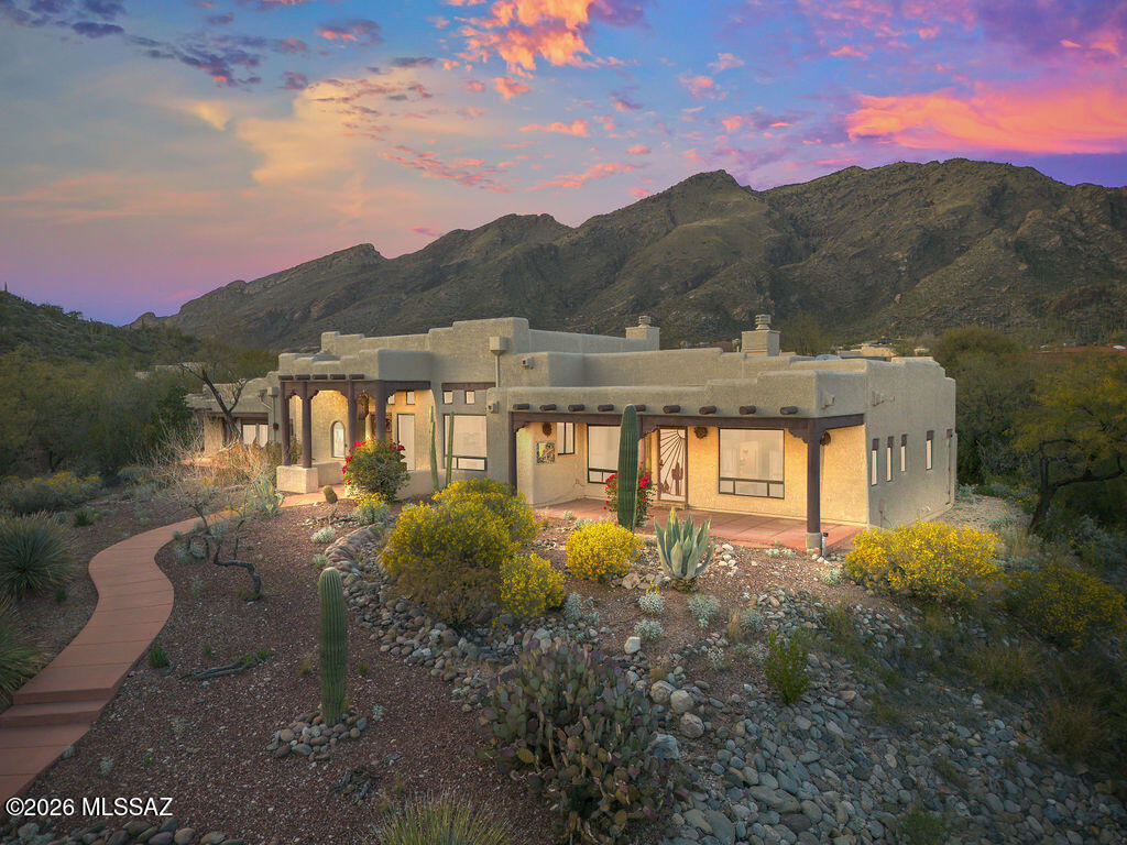 Welcome home to Luxury, Light, and Views for days.

Located in Alta Vista within the prestigious Catalina Foothills, this stunning residence captures sweeping mountain views by day and sparkling city lights by night. From the moment you step inside, soaring cedar ceilings and beautiful exposed viga beams create warmth and custom architectural character, while walls of windows frame Tucson's sunsets like living artwork.

The split floor plan offers the perfect blend of openness and privacy, ideal for both everyday living and entertaining. The living spaces feel expansive yet inviting, and the private primary suite is a true retreat with peaceful views that make mornings feel slower and evenings more serene. Each bedroom is ensuite with patios enjoined. And then... the extras that are hard to find.

A rare RV garage provides flexibility for adventure, toys, or additional vehicles, a rarity, extra A/C and heated workshop. There is also abundant storage throughout the home, giving you space to live beautifully without sacrificing organization.

Step outside to your own backyard escape, complete with a Pebble Tec pool, spa perfectly positioned to take in the surrounding views. Whether it's sunrise coffee, afternoon swims, or sunset BBQ gatherings under the city lights, this is Arizona living at its finest.

Peaceful. Elevated. Rarely available. Thoughtfully designed with luxury views, timeless character, and space to truly breathe.