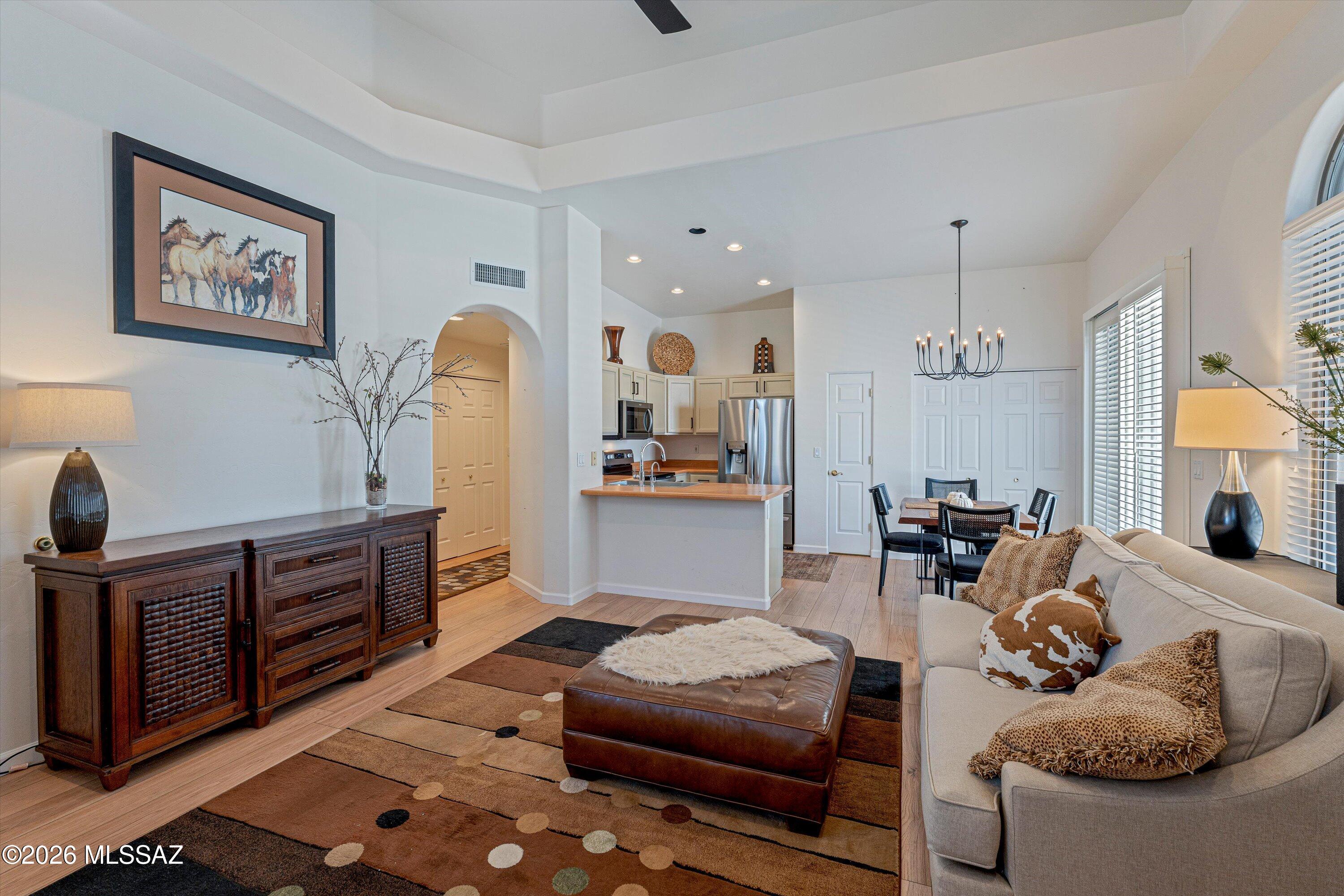 Welcome to this charming townhome in Northwest Tucson! Located in a 55+ gated community with beautifully landscaped grounds, residents enjoy access to a pool, spa, and rec center. HOA covers water, sewer, waste pickup, community landscaping, tile roof, exterior maintenance, and gated entry. Wonderful low-care home features soaring cathedral ceilings, a bright great room floor plan, and abundant natural light throughout. Mountain views enhance the space, while laminate flooring, custom window coverings, accented interior paint, and an updated walk-in shower with grab bars add comfort and style. Spacious bedroom includes two closets. Enjoy mountain views and Arizona sunsets from two private patios in a quiet interior location. Conveniently located near dog park, Ann Day Community Park, YMCA, Nanini Library, grocery shopping, dining, medical facilities, and easy access to I-10.