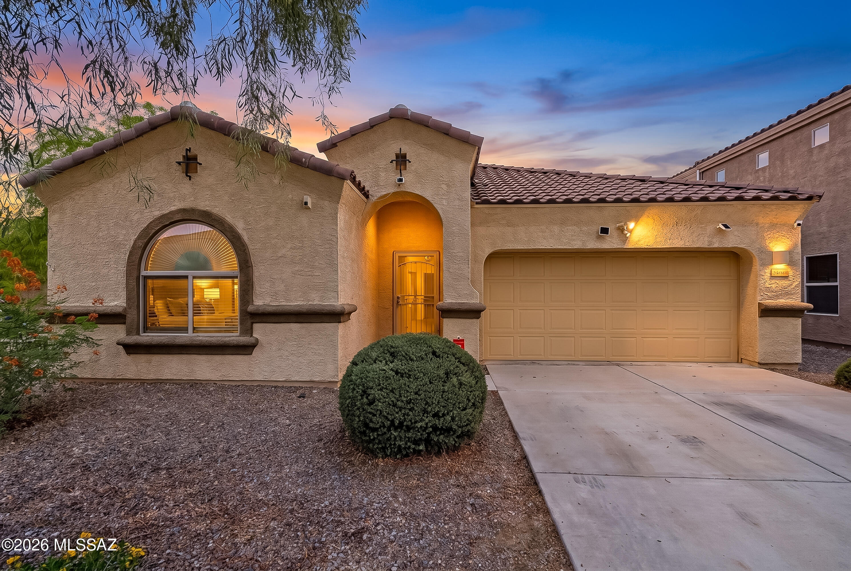 Welcome home to this move in ready popular ranch-style floor plan designed for easy living and entertaining. Paid-off solar panels help keep electric costs exceptionally low. The spacious kitchen opens to the great room and features an extra large island, upgraded maple cabinetry with espresso finish, granite countertops, stainless steel appliances, and a professional-style faucet.  Upgraded 18x18 ceramic tile and quality carpet and padding add comfort and style throughout. The home has been thoughtfully enhanced with LED lighting, updated cabinet hardware, added laundry room cabinetry, a whole-house water softener, upgraded high-volume R.O. system, and even a new microwave. Additional touches include window blinds, a wired video doorbell, smart thermostat, upgraded garbage disposal, security cameras and a built-in termite control system. Step outside to a beautifully landscaped backyard featuring mature fruit trees and a spacious shaded patio, creating a peaceful spot to relax, entertain, and enjoy Arizona's outdoor lifestyle.