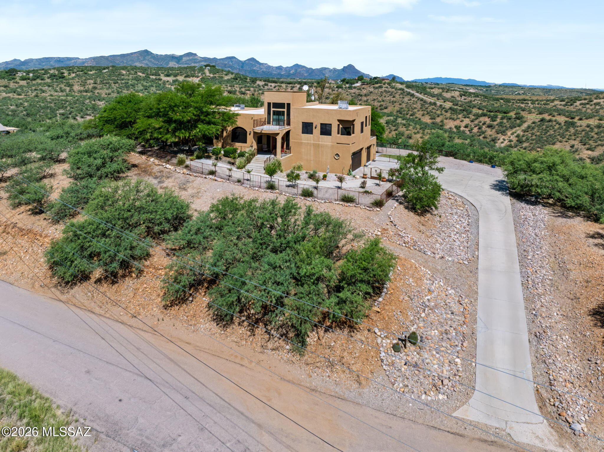 Rising above the desert landscape, this multi story retreat unfolds like a private sanctuary of light, texture and panoramic beauty. Pristine Saltillo tile glows beneath soaring spaces, while alderwood cabinetry and granite surfaces anchor the chef's kitchen opening to a balcony suspended over endless horizons. The upper level principal suite becomes a cinematic escape with a flex lounge and its own terrace for sunrise rituals and sunset reverie. With 4 bedrooms, 3 baths, underground utilities, RV parking and a lower level garage with dog run potential, the home blends sculptural architecture with breathtaking views. Great family home! P 200 Character Hyper Luxury Overflow
A Kodiak Yamaha 400 4x4 with sprayer conveys. Additional dining area balcony, artisan finishes, and unforgettable sunsets complete this elevated desert haven.