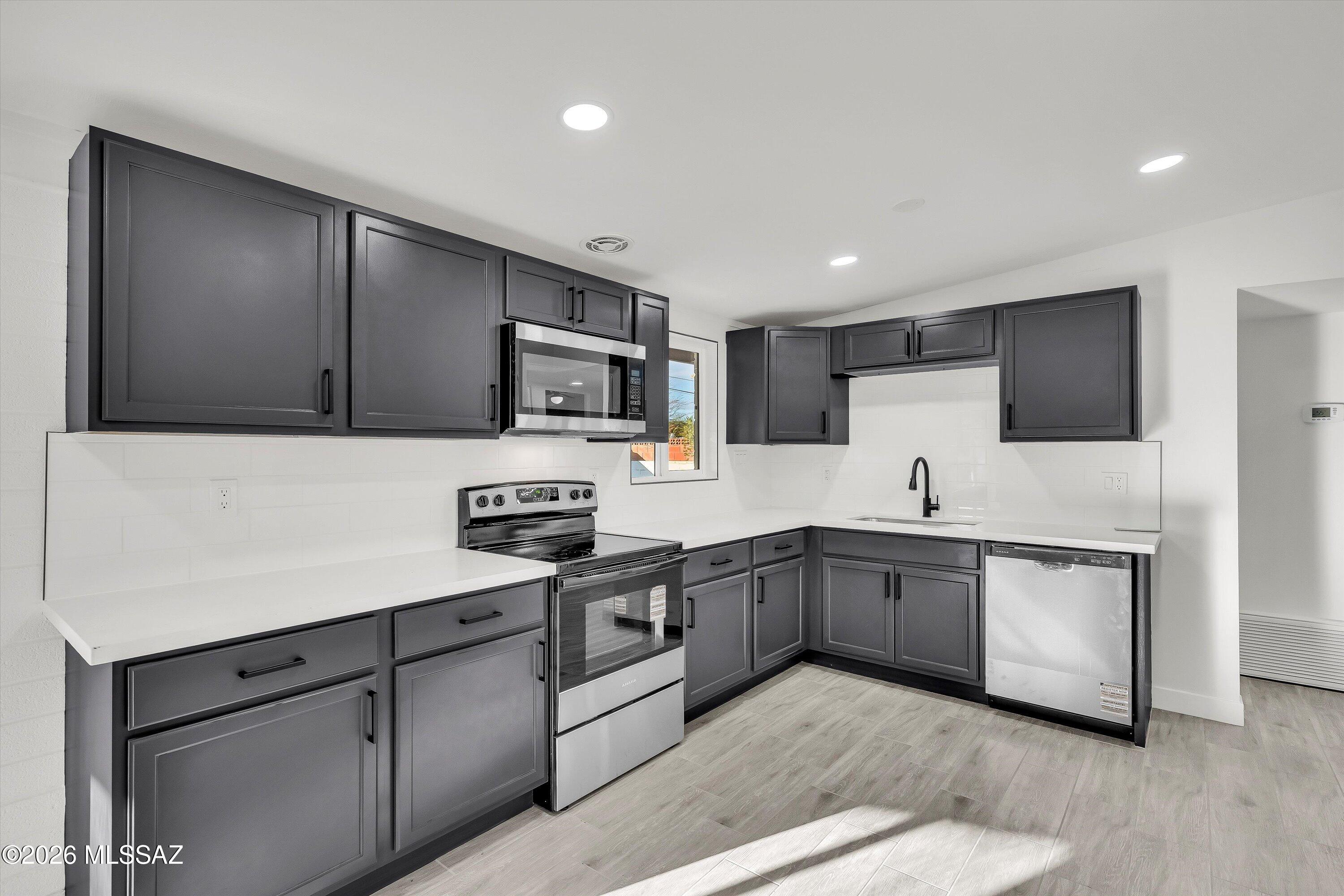 Beautifully remodeled 4-bedroom, 2-bath home in a prime location close to shopping, restaurants, local parks, schools, and just minutes from Davis-Monthan Air Force Base. This light-filled home features large windows that create a bright, welcoming atmosphere. The updated kitchen showcases brand-new stainless steel appliances and modern finishes, offering both style and functionality. The spacious primary suite includes a private ensuite bathroom for added comfort. Step outside to enjoy a charming front porch, low-maintenance landscaping in both the front and backyard, and a generous backyard with a covered patio and storage shed, perfect for relaxing or entertaining. Ample parking, including RV parking, provides added convenience and flexibility. Move-in ready and thoughtfully updated, this home offers comfort, practicality, and an unbeatable location.