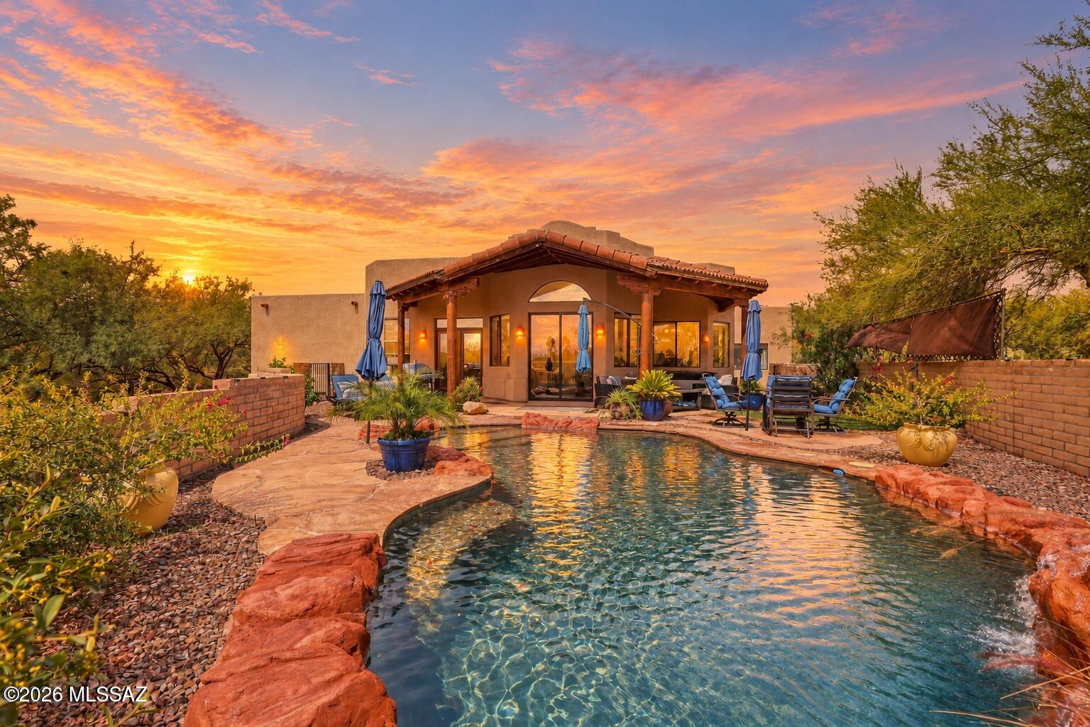 Enjoy panoramic Santa Rita Mountain views from this distinctive 3-bedroom, 2-bath Green Valley home offering 1,762 sq ft on an expansive 20,723 sq ft lot. Step inside through an impressive 16-foot foyer tower with display niches, setting the tone for the home's custom character. The spacious backyard is designed for Arizona living with a private pool, large patio and beautiful mountain backdrop. Additional highlights include PAID-OFF SOLAR, a 2-car attached garage, HVAC replaced in 2022 and roof recoated in 2022. All of this with an HOA of only $33/month. A unique property combining space, views, efficiency and inviting indoor-outdoor living.