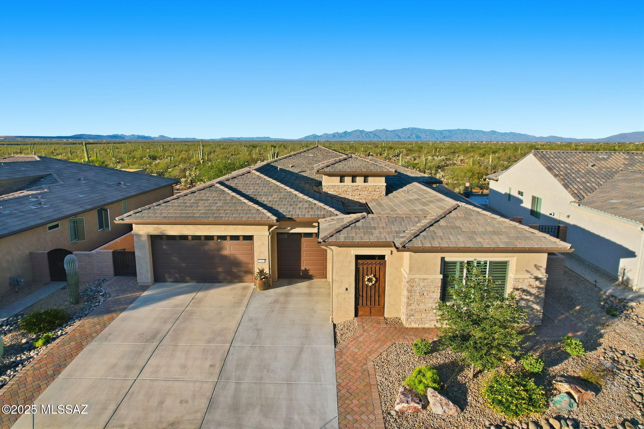 Some homes have a view. This one has a front-row seat to the beauty of the Sonoran Desert. Set against breathtaking panoramic north-facing vistas, this exceptional Vienta floor plan blends refined finishes, thoughtful upgrades, and seamless indoor-outdoor living in the heart of Quail Creek. Striking curb appeal welcomes you to an enclosed front courtyard and private casita--an inviting retreat for overnight guests, hobbies, or extended stays--complete with built-in cabinetry and a beautifully tiled shower with glass enclosure. Step inside and the attention to detail is immediately apparent. Coffered ceilings accent the foyer, primary suite, and den, complemented by upgraded cabinetry, crown molding, 5.25-inch baseboards, plantation shutters, and high-end ceiling fans. At the heart of the home, the expansive kitchen makes a statement with an oversized granite island, additional upper cabinetry, soft-close and roll-out shelving, RO water system, and premium Signature stainless steel appliance package. A dramatic stackable sliding glass door opens the living space to the patio, creating an effortless flow for entertaining and enjoying those incredible views. The extended primary suite offers a peaceful escape with a spa-inspired bath featuring a curbless roll-in shower and custom California Closets system. Even the laundry room is thoughtfully finished with abundant cabinetry and a utility sink. Car enthusiasts and hobbyists will appreciate the extended 3-car garage with a four-foot extension, epoxy flooring, side-mount opener, windows, service door, mini-split system, utility sink, Kinetico water system, and added insulation. Additional upgrades include a tankless water heater with recirculating pump, rain gutters, and smart-home automation with an alarm system, automated door locks, and thermostat.Outdoors, the Arizona lifestyle takes center stage. Travertine decking creates an elegant setting for relaxing or entertaining, while electric roll-down patio shades provide added comfort. Discreet mesh fencing helps keep desert wildlife at bay without distracting from the beauty of the surrounding landscape and panoramic views.Exceptional views, impressive upgrades, a private casita, and outstanding indoor-outdoor living--all paired with the resort-style amenities of Quail Creek. This is desert living beautifully done.