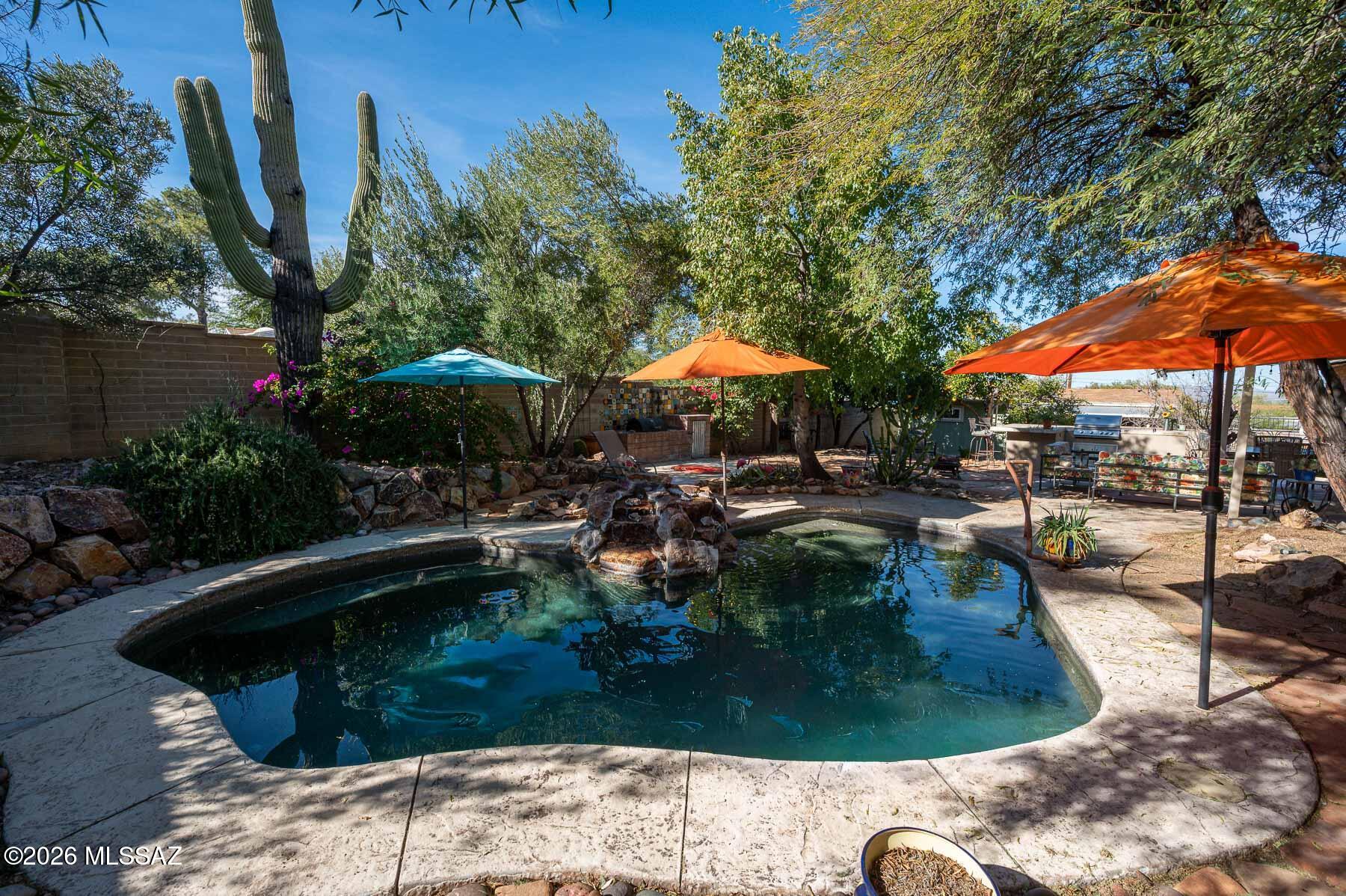 Timeless Ranch Retreat! Fabulous 3 bedroom 2 bath brick home features effortless living with large windows, accessible spaces, & outdoor patio for entertaining. Attached cozy 1 bedroom 1 bath guest quarters has its own private access (multi-generational). A separate cooled studio/office can be used for additional storage, craft room or work out area. Bright open kitchen features stainless steel appliances, quartz countertops & plenty of cabinet space. Other charming attributes include solid wood doors throughout, closets with custom built-ins, ceramic Mexican tile accents, Saltillo tile flooring and wood burning fireplace. Versatile outdoor space allows for RV parking & Big Toys. Private backyard oasis with a beautiful Pebble Tec Pool and lush vegetation. Ranch style living at its best!