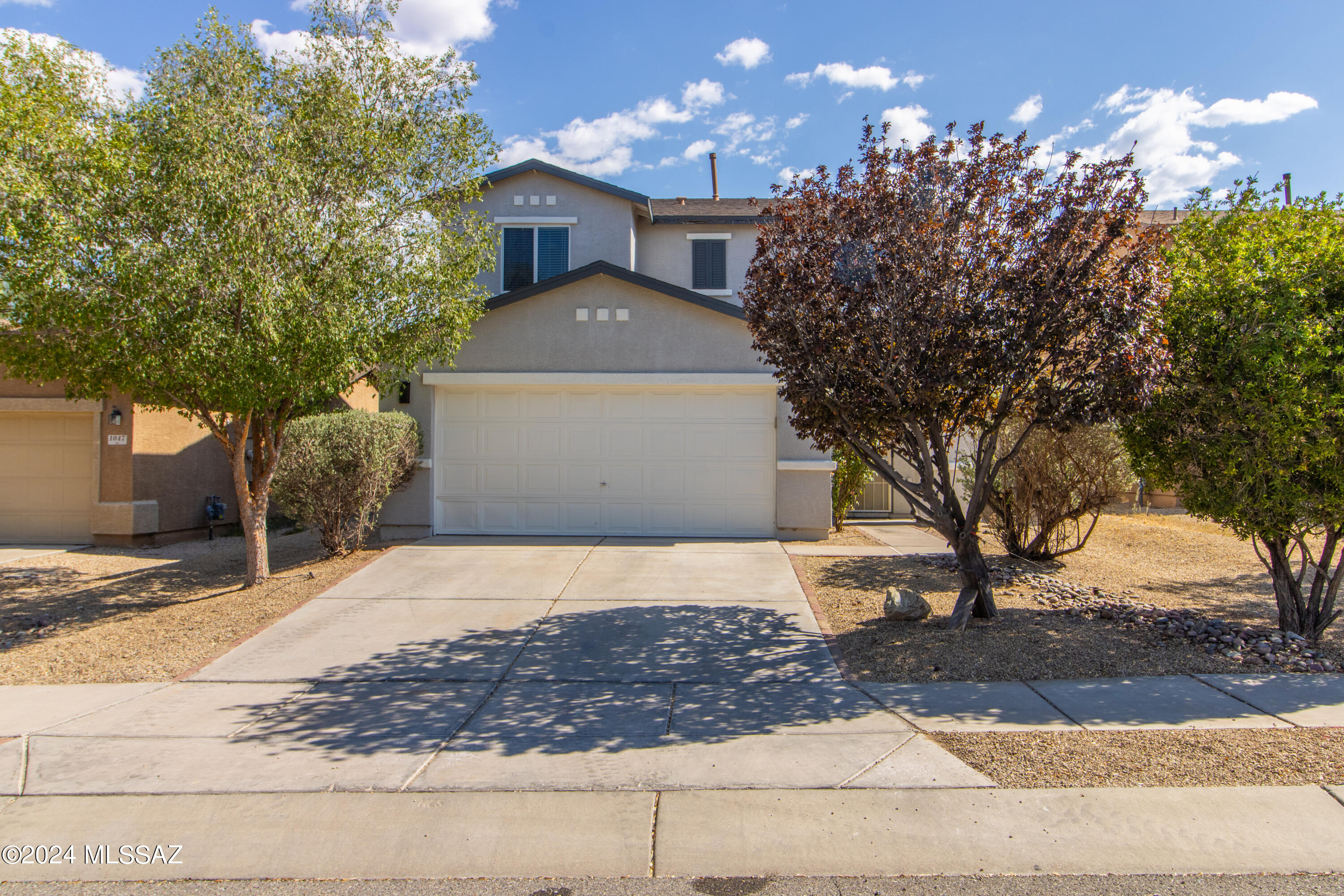 Take advantage of space, privacy, and breathtaking Santa Rita Mountain views. all at a value that's hard to find in this neighborhood. This thoughtfully designed home features an open-concept layout with a spacious great room that flows seamlessly into a grand dining area, perfect for entertaining. A private foyer with a custom security front door creates a warm and welcoming first impression. The bright, inviting kitchen offers abundant cabinet and counter space, complemented by a stylish backsplash and stainless steel appliances, deal for both everyday living and hosting. Upstairs, you'll find generously sized bedrooms, 2.5 baths, and a versatile loft that makes a perfect home office, playroom, or second living space.