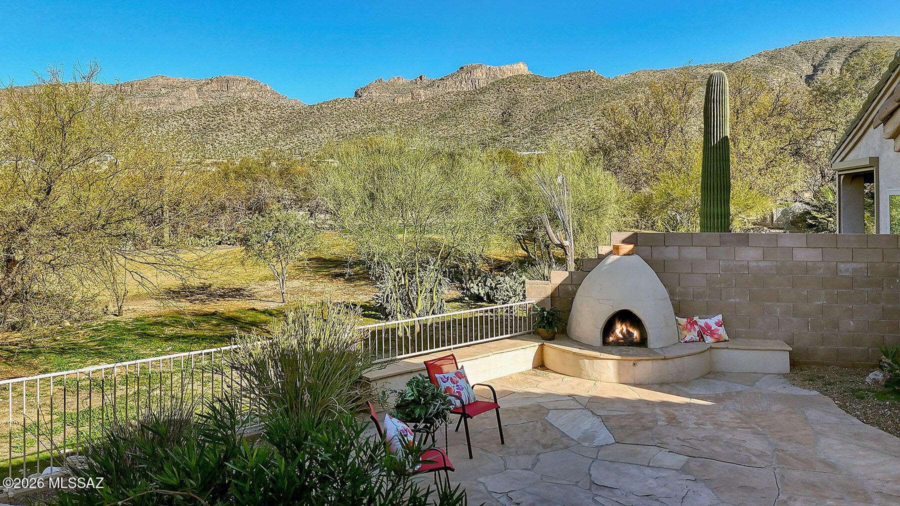 Nestled in the master-planned, 24-hour guard-gated community of Sabino Springs, this contemporary 1,350 sq ft home offers stunning mountain and golf course views. New roof just installed!  New stainless-steel appliances recently installed in Kitchen (May). The thoughtful split floor plan features 2 bedrooms, 2 baths, plus a separate den/office, with a bright open great room, dining area, and cozy fireplace. Enjoy seamless indoor-outdoor living from the west-facing flagstone patio with outdoor fireplace, bunco area, and views over the common area and Arizona National Golf Course.  Community amenities include a recreation center, pool, and easy access to hiking trails, schools, and parks--perfect for relaxed desert living. Welcome Home!